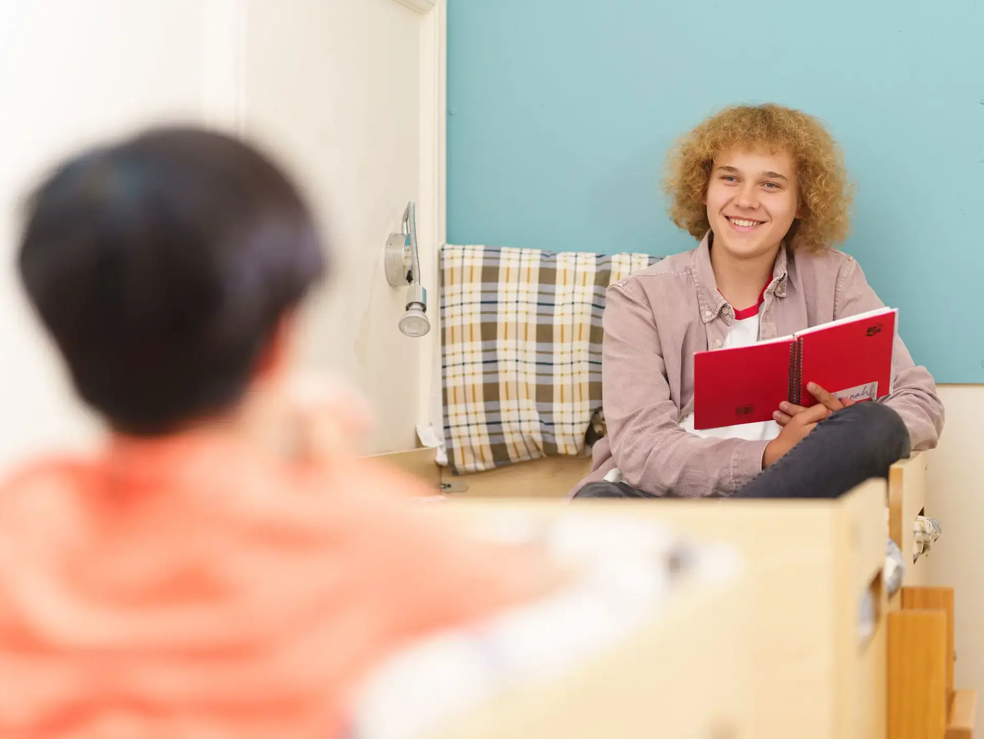 Students sitting on bed, reading