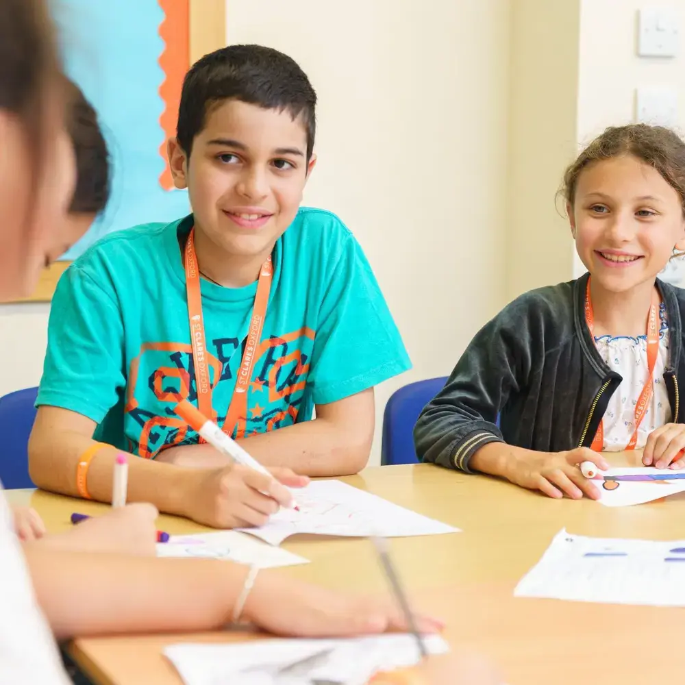 Junior students in class together and smiling