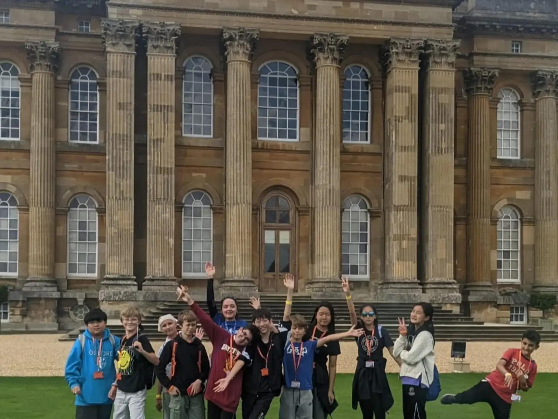 Students posing outside palatial building