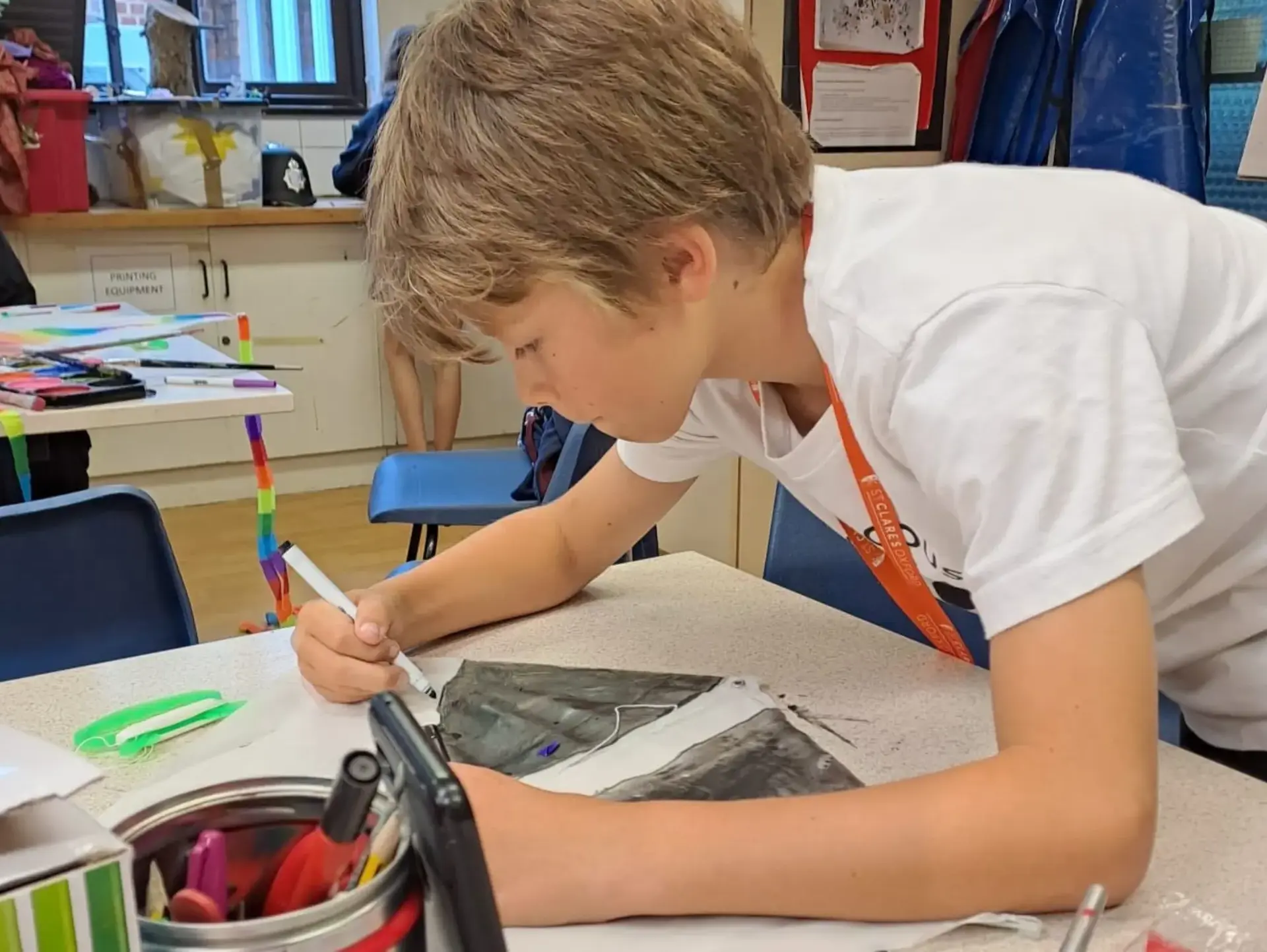 Student writing with marker pen