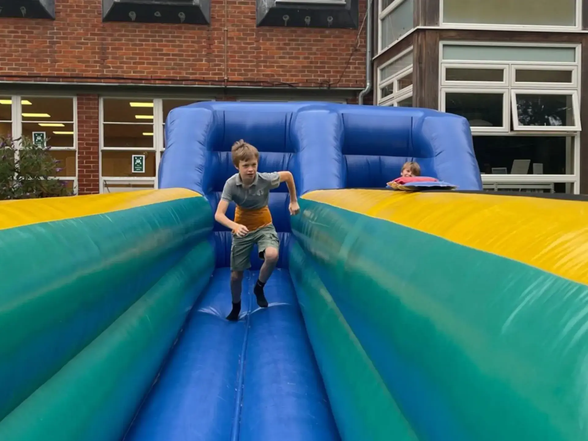 Student running across bouncy castle