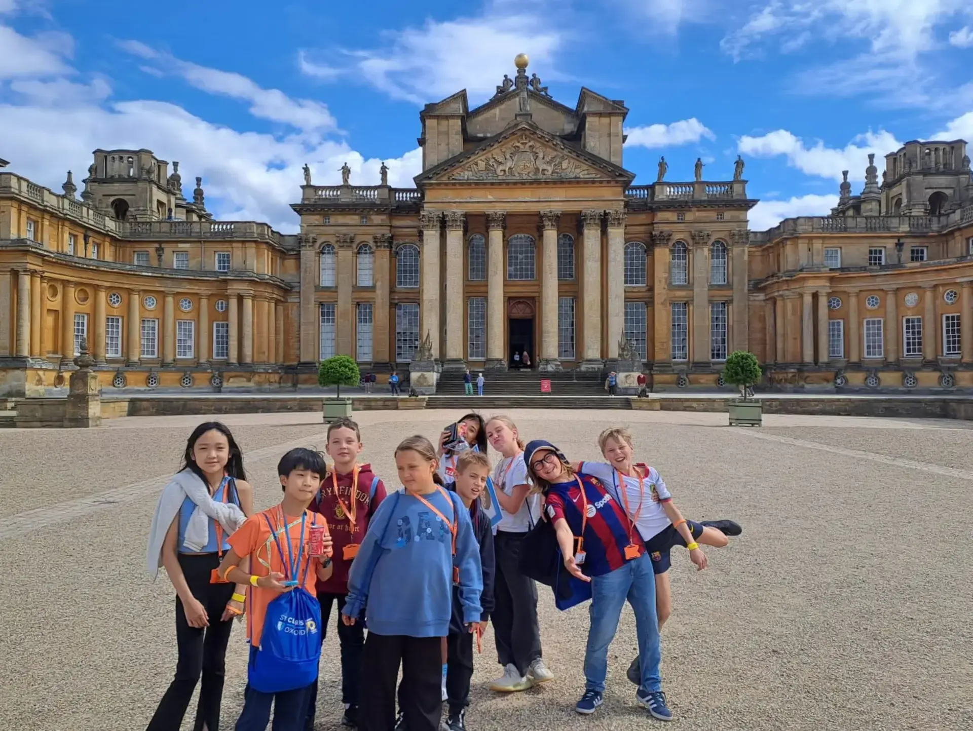 Students posing in front of palatial building