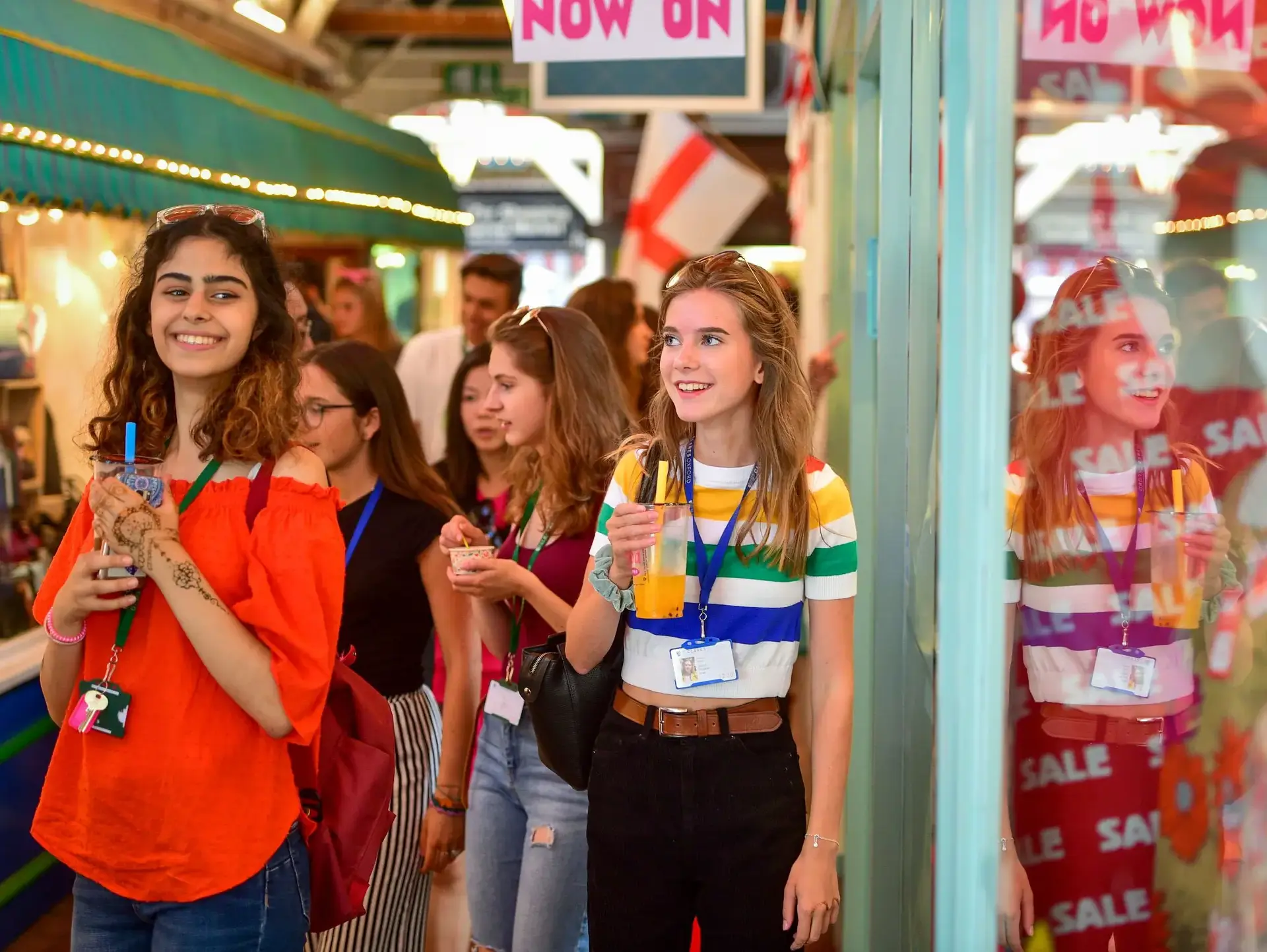 Students walking through market, holding bubble tea