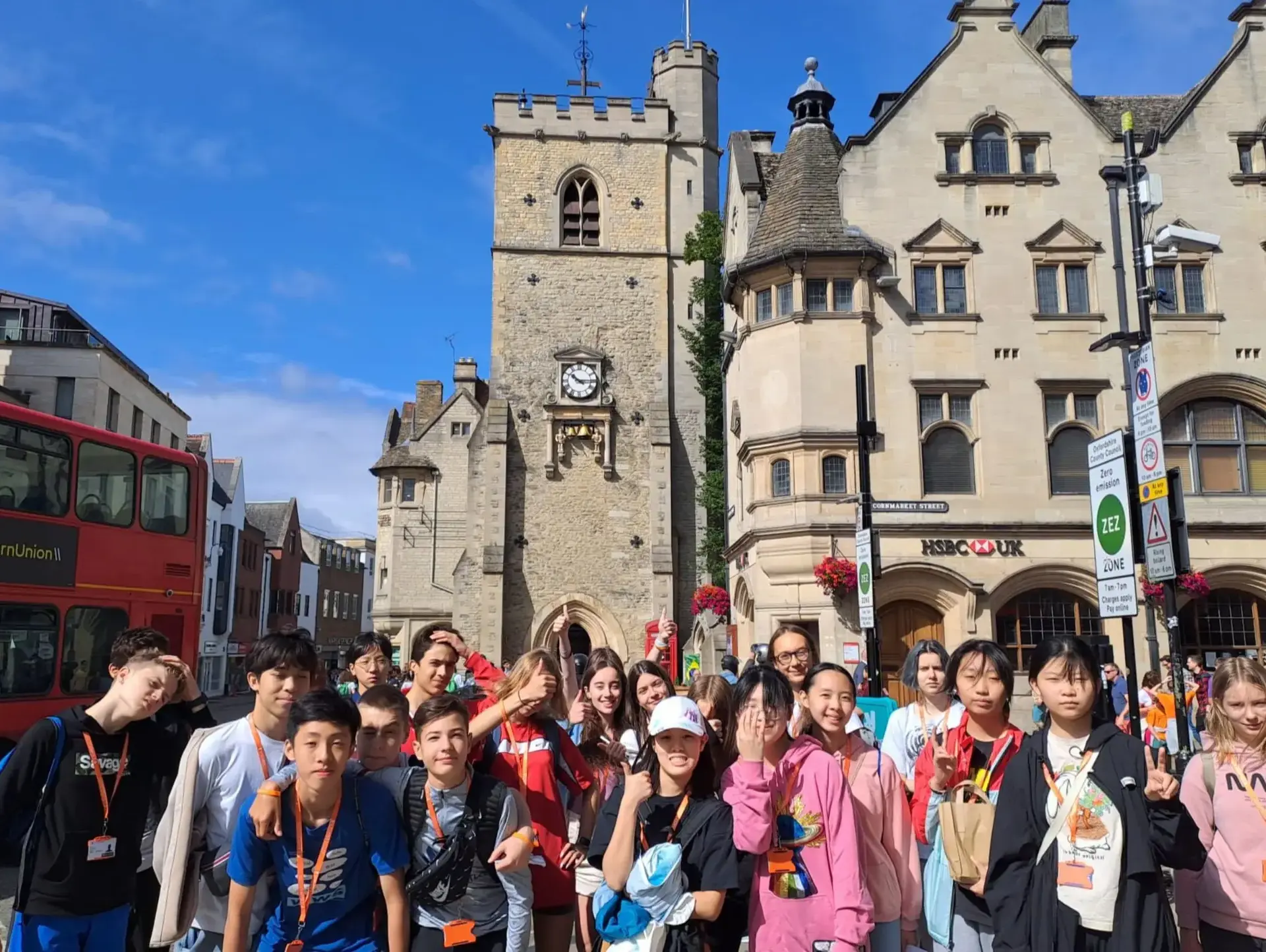 Group of students posing in front of clock tower