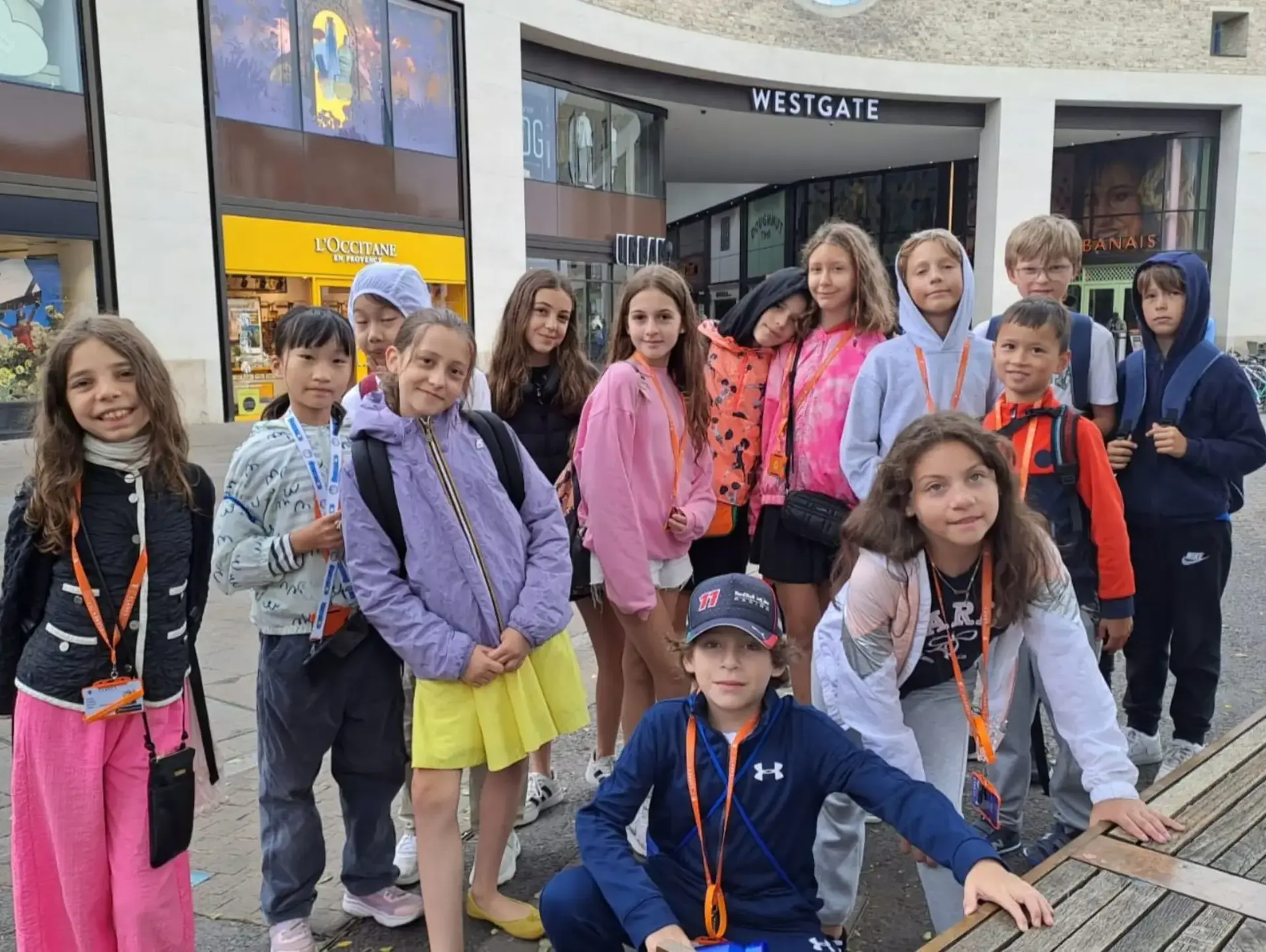Group of students pose for photo in shopping centre
