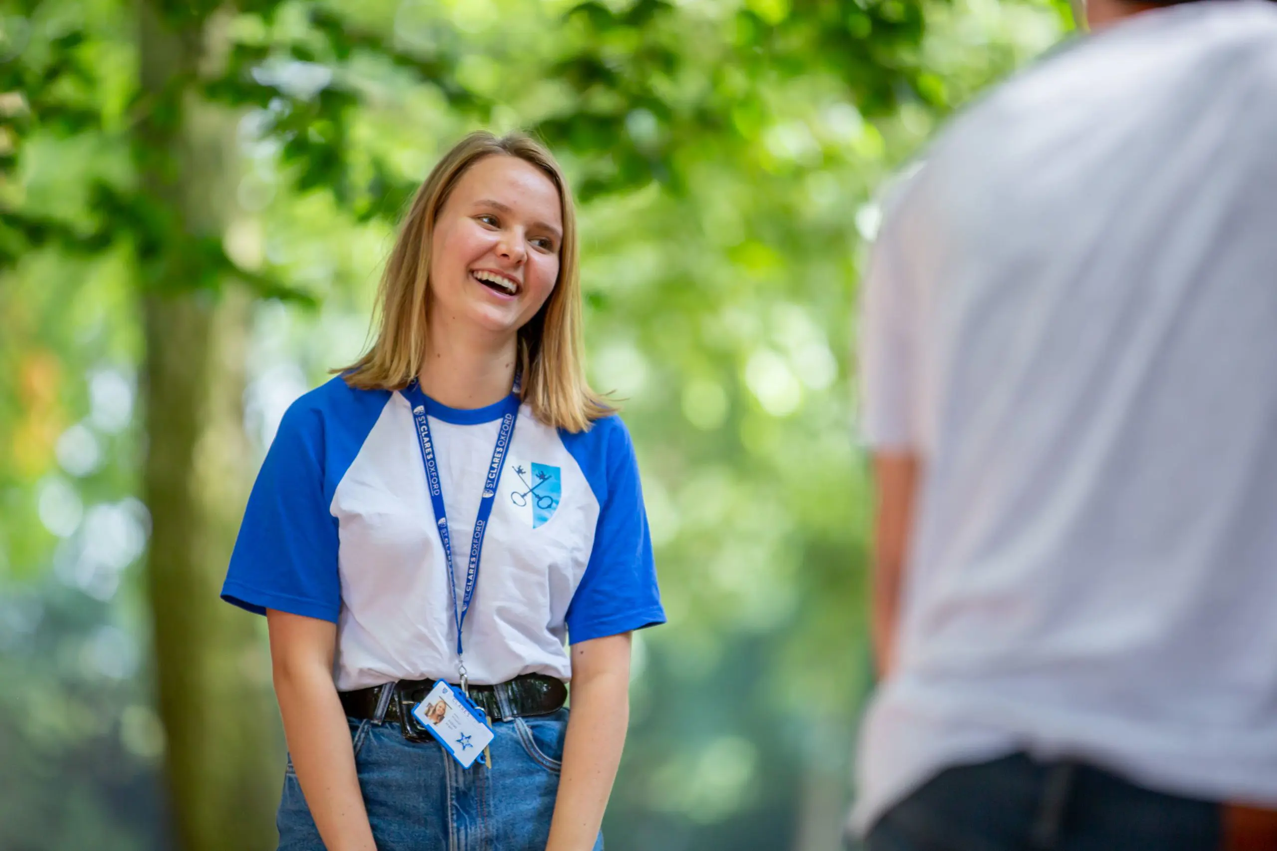 Smiling welfare officer wearing lanyard
