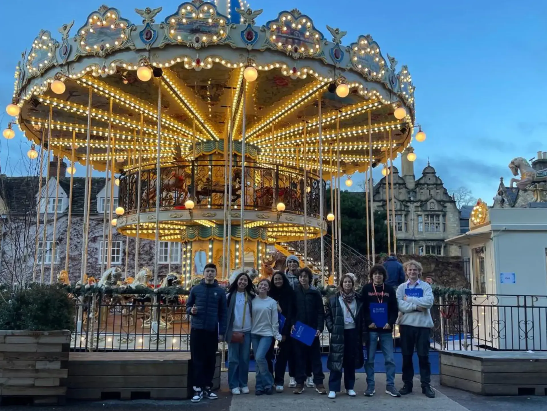 Students standing in front of carousel