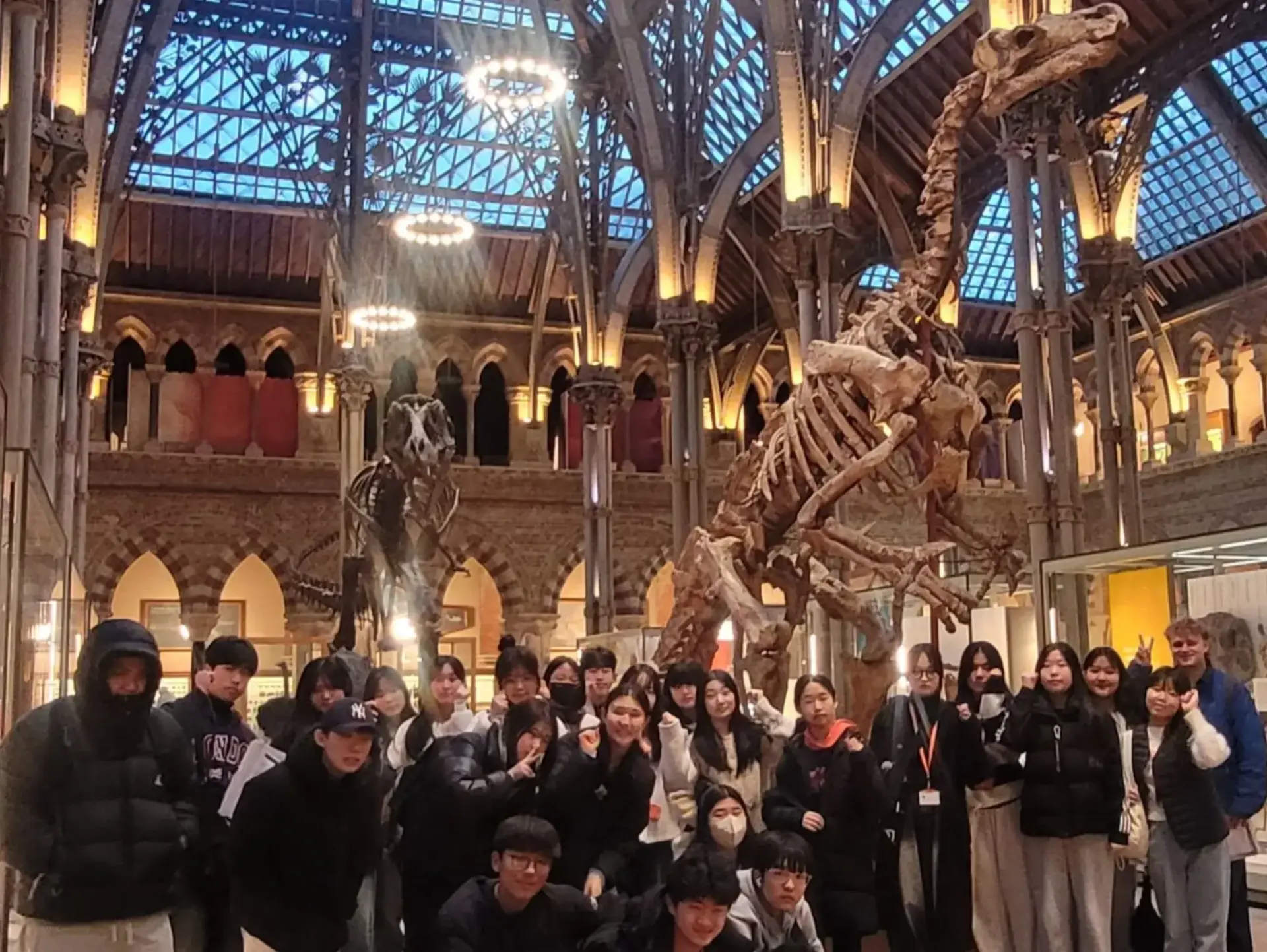 Students standing in front of dinosaur skeleton