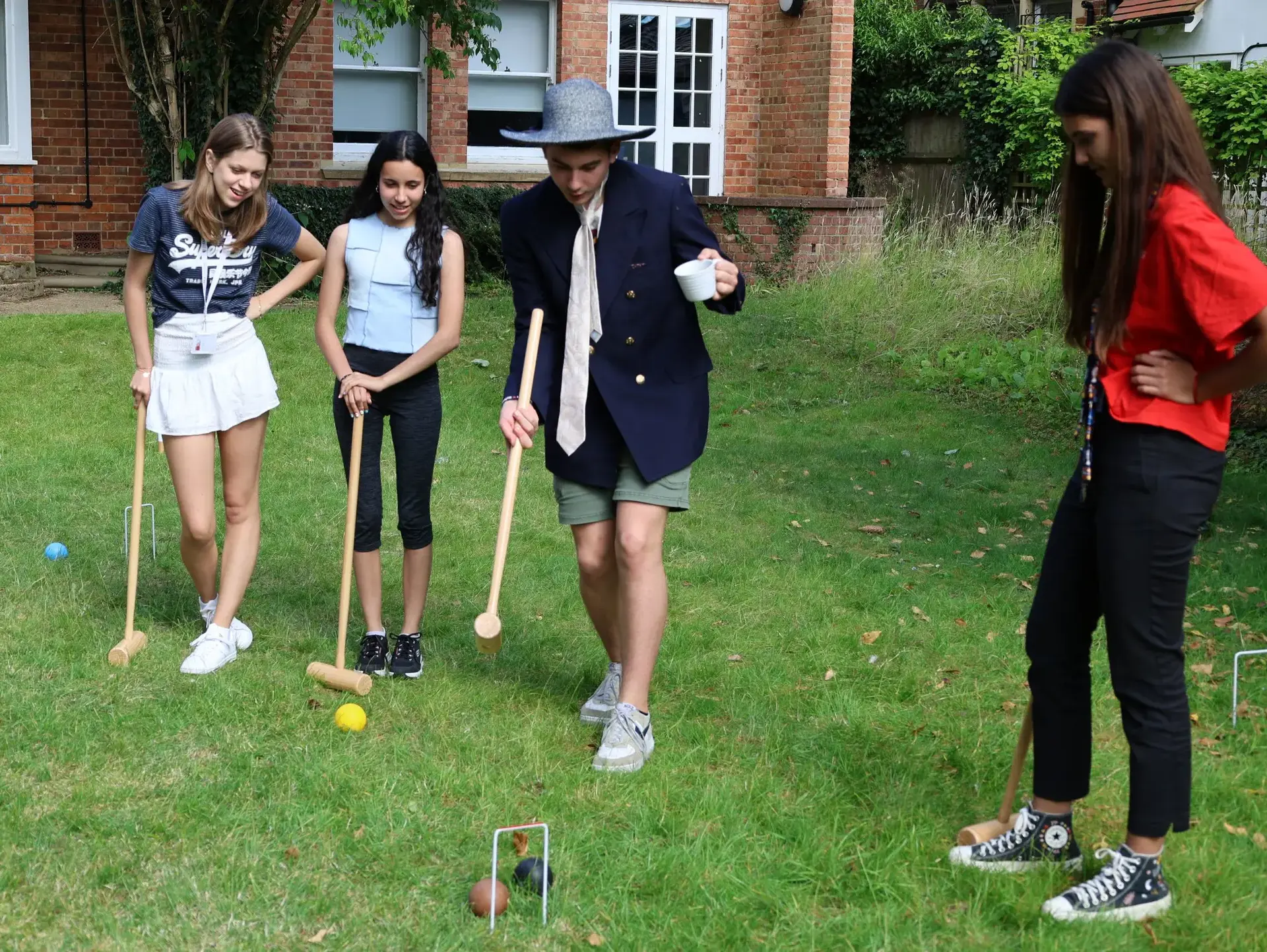 Students playing croquet