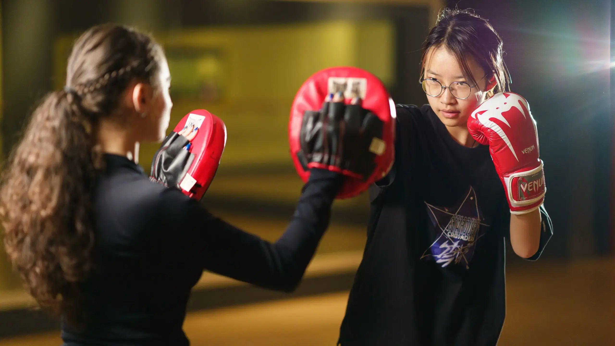 Students practising boxing with pads