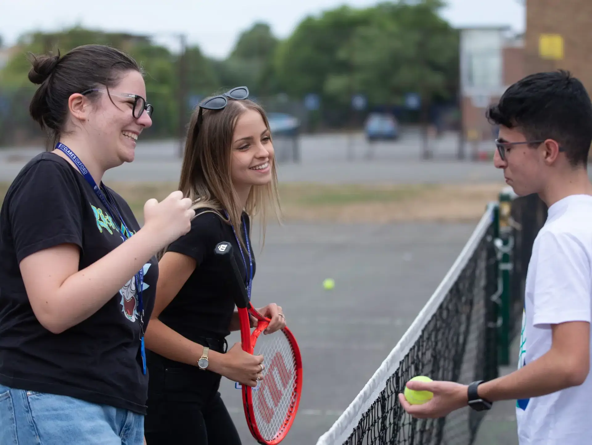 Students chatting over badminton net