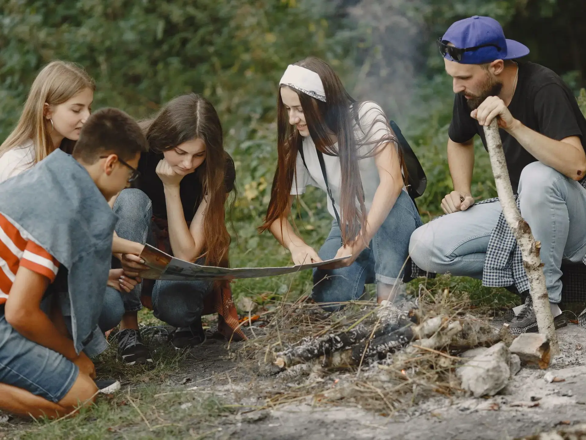 Students surrounding campfire