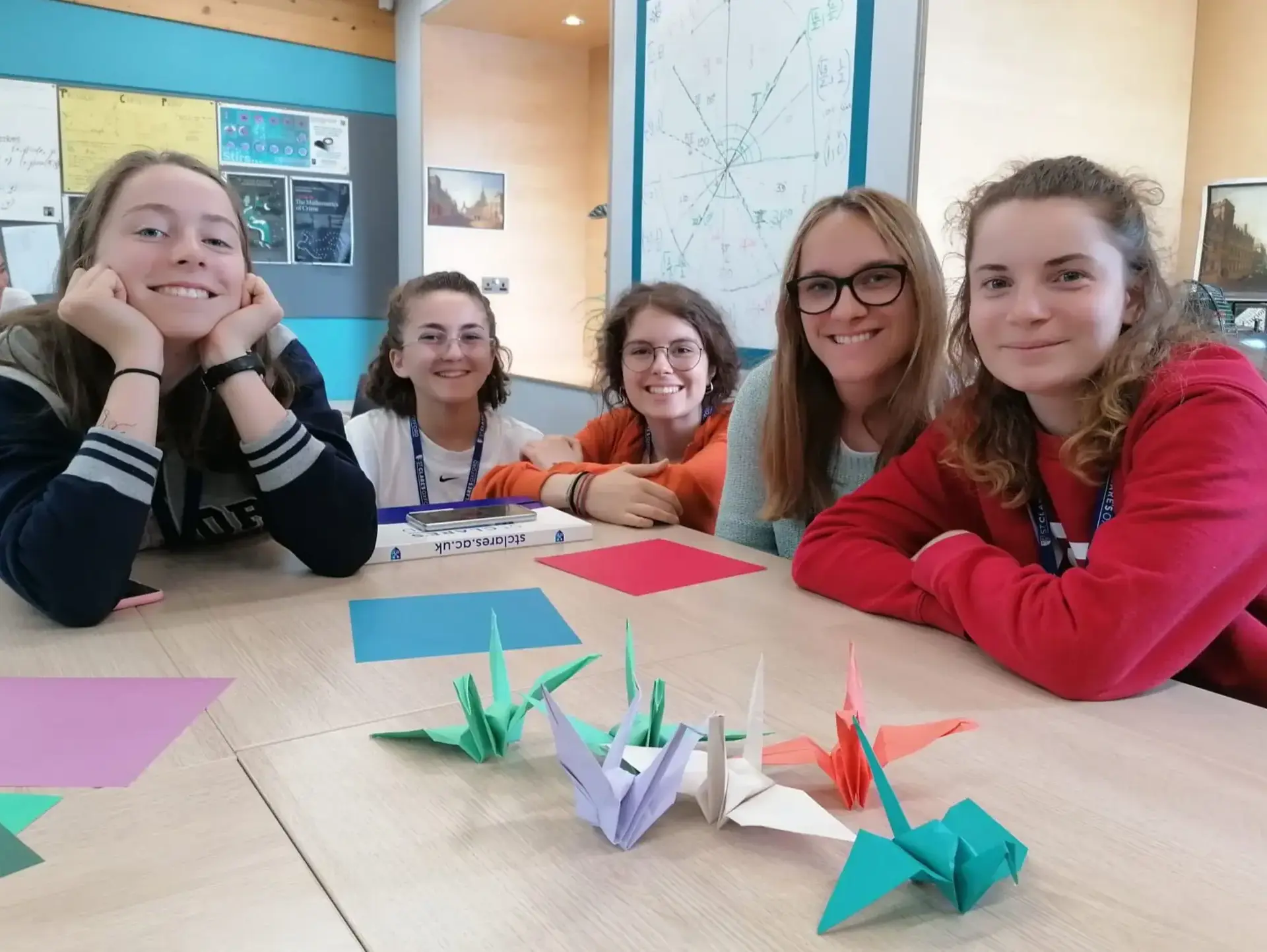 Students showing off origami