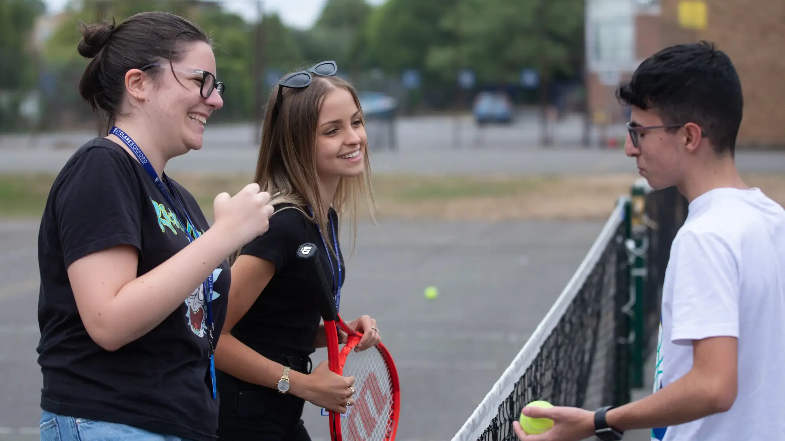 Students chatting over badminton net