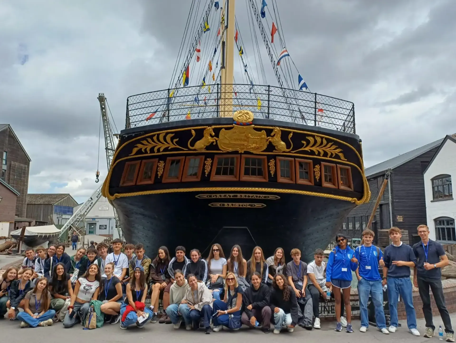 Students posing in front of tall ship