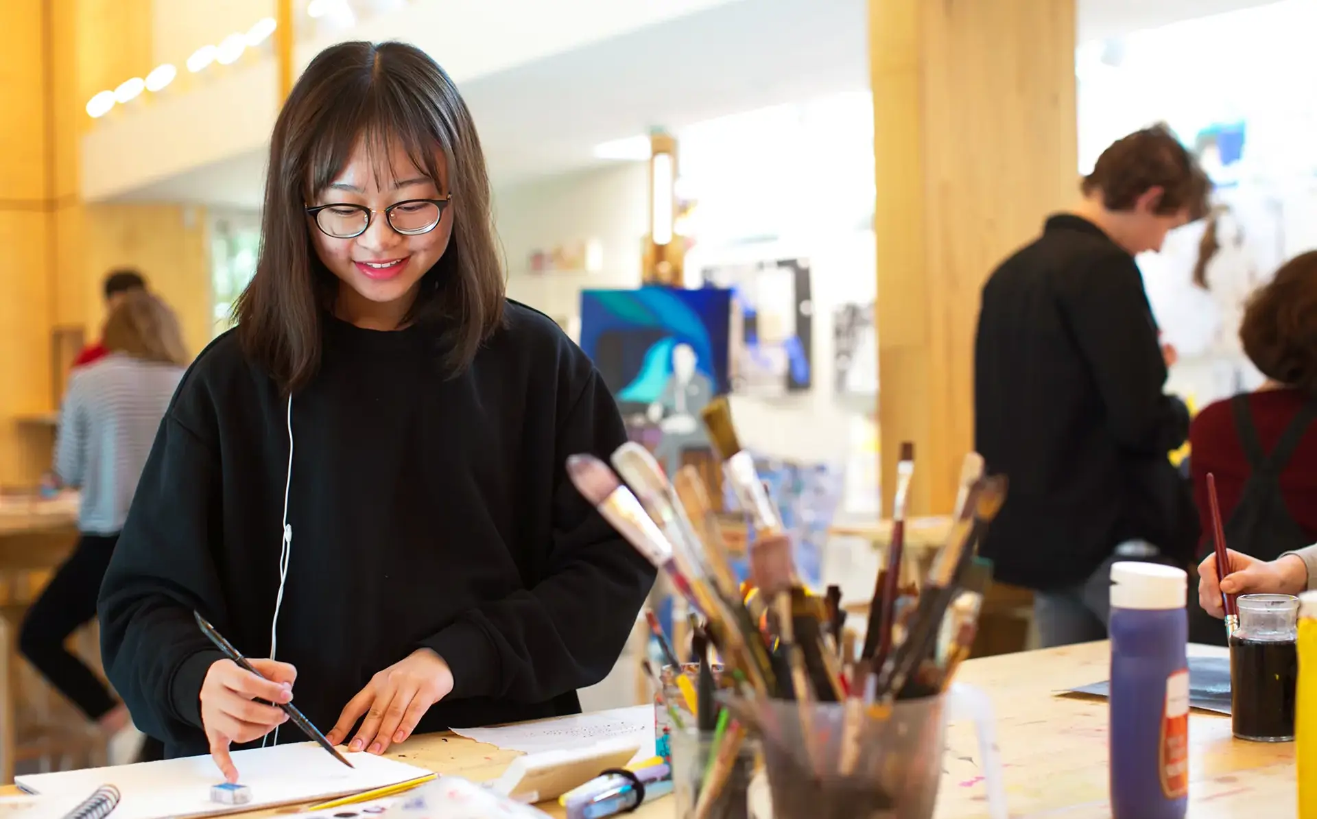 Smiling student painting