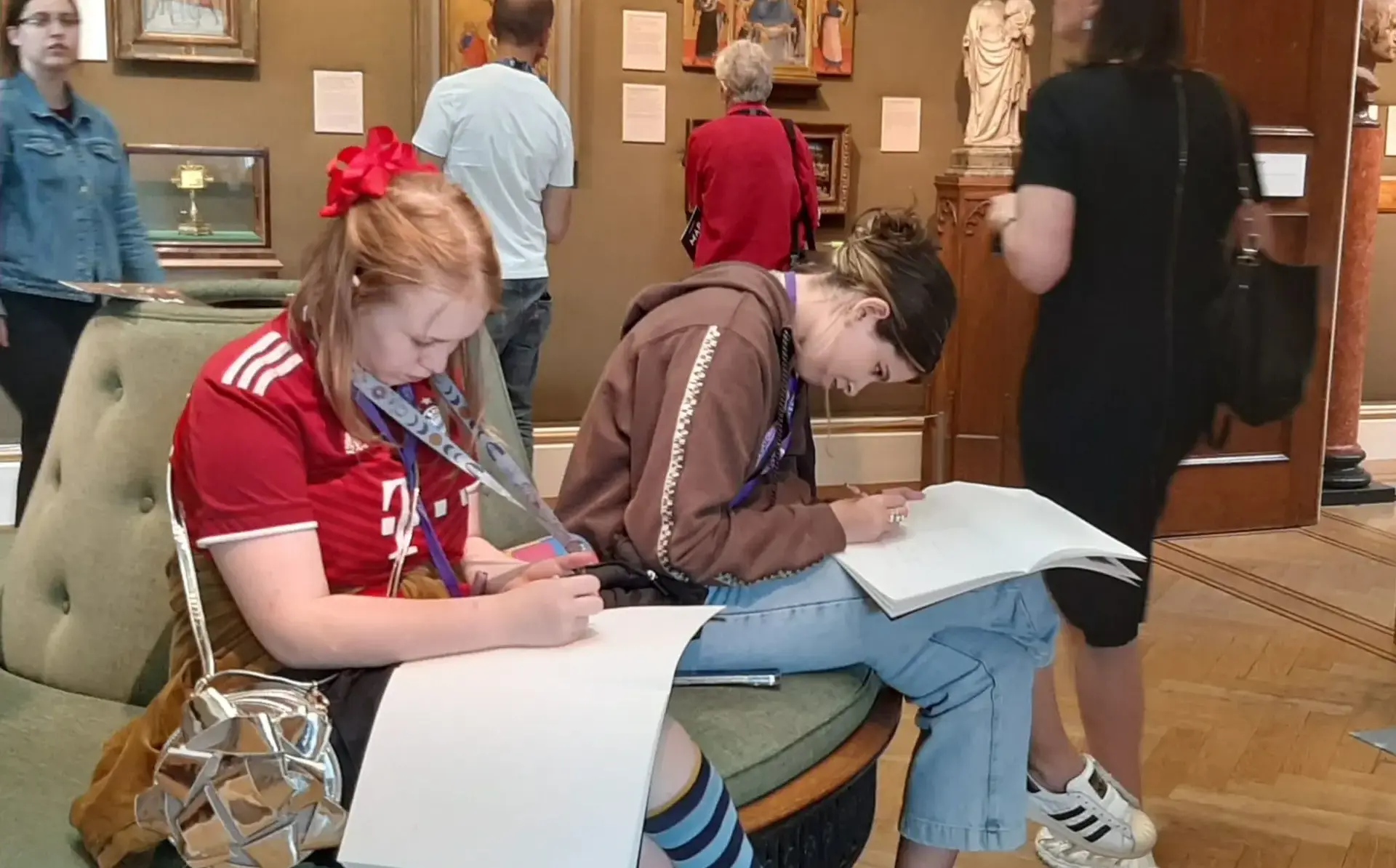 Students sketching in art gallery