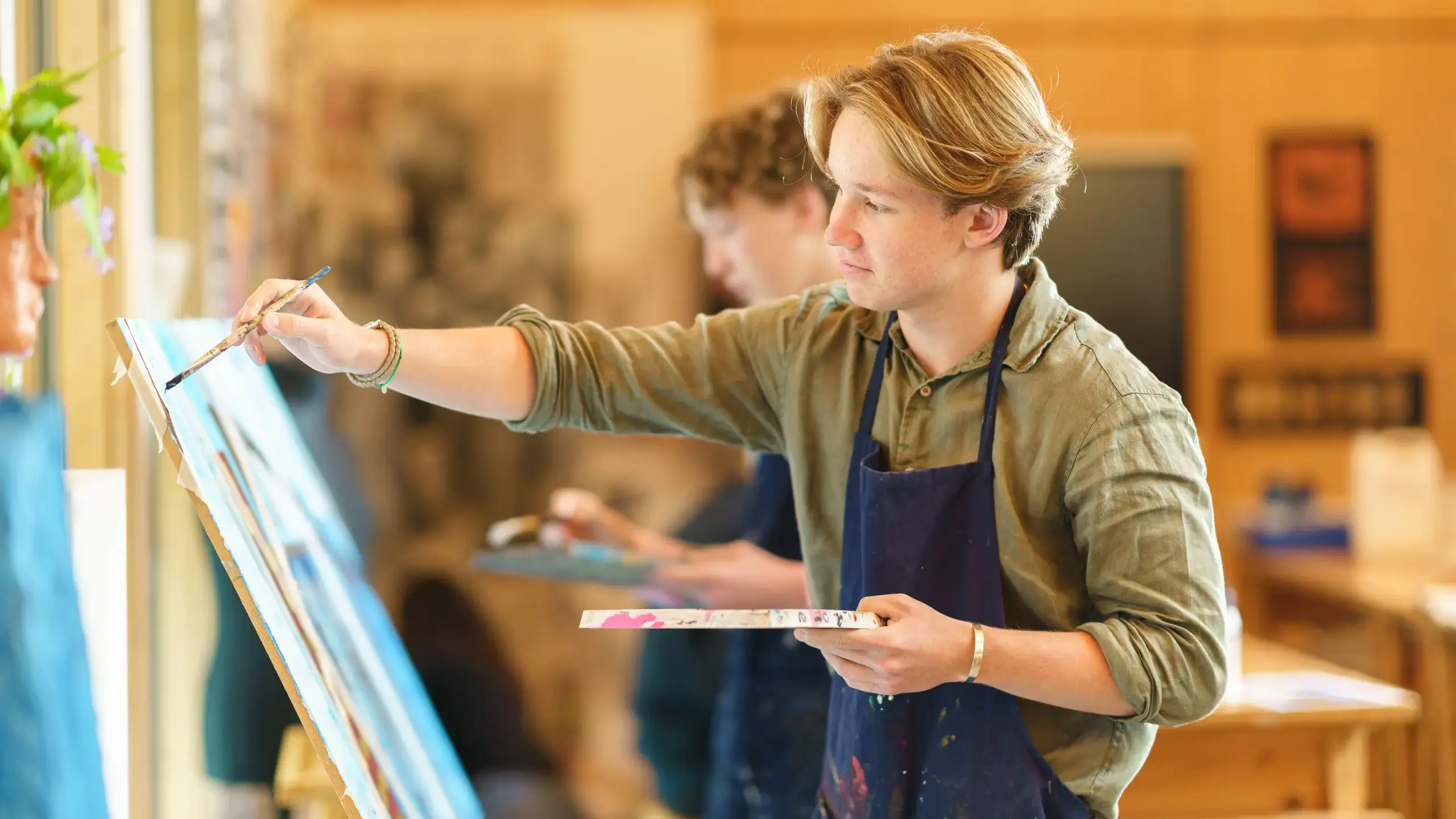 Student painting at easel