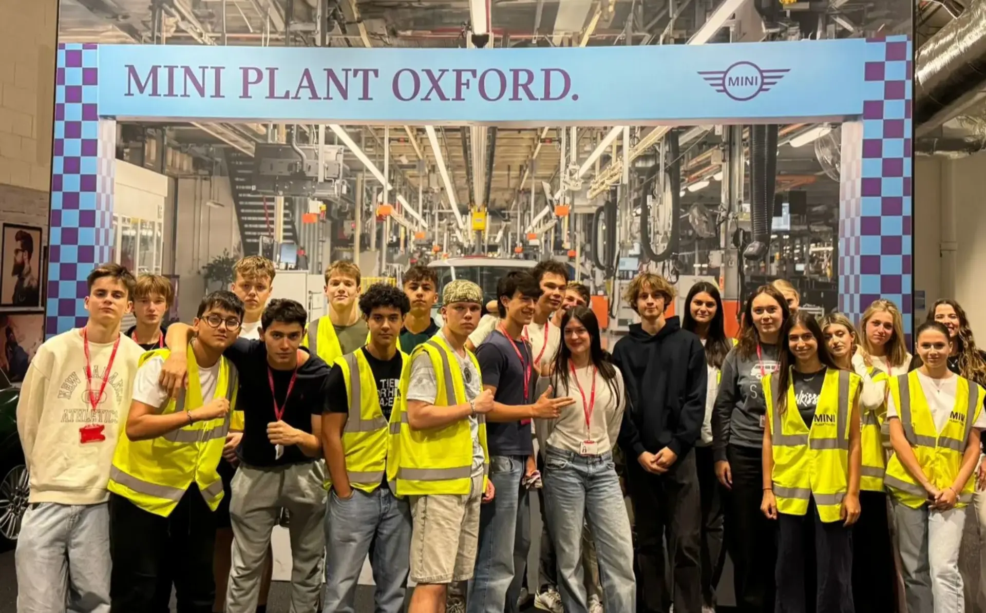 Group of students wearing high viz in factory