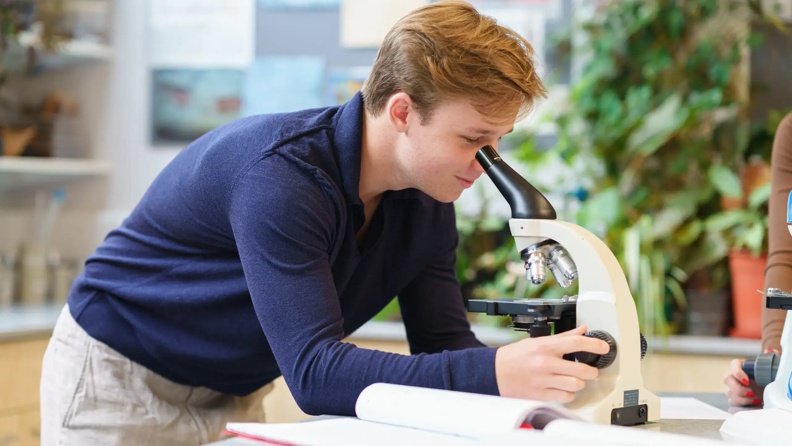 Student looking into microscope