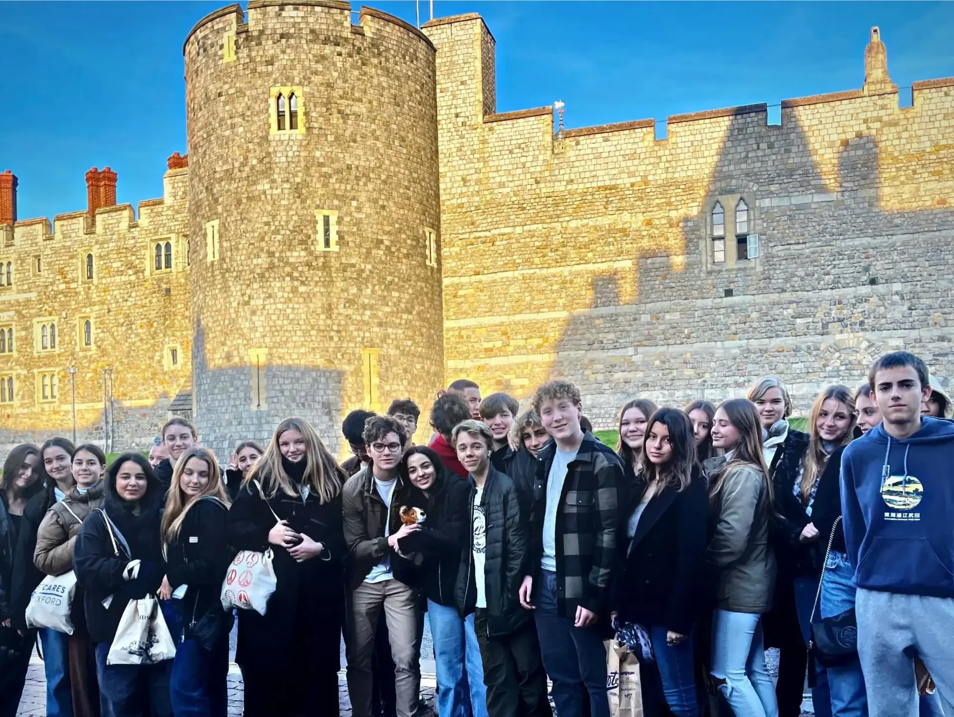 Students posing outside castle