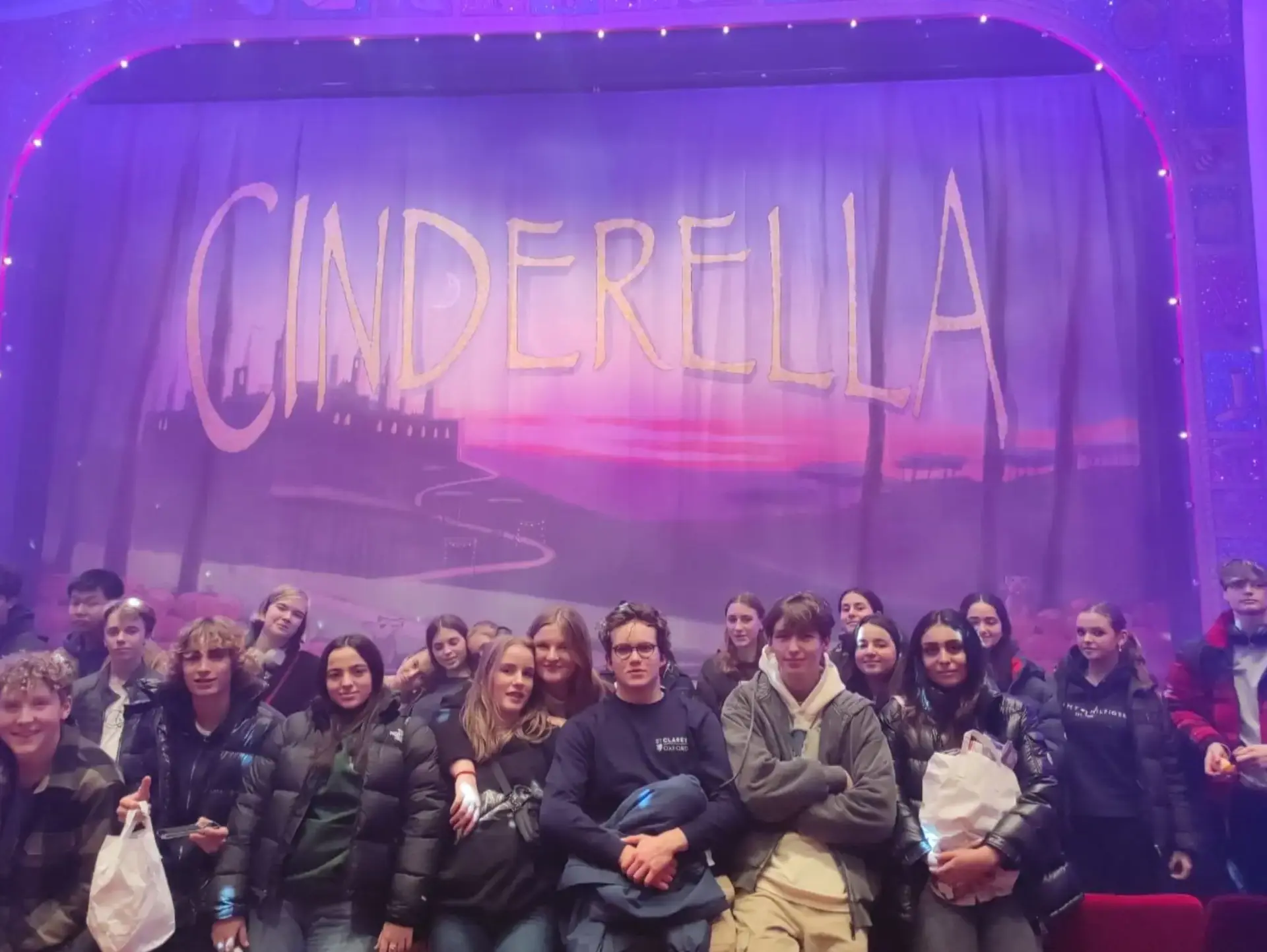 Students posing next to staging for Cinderella