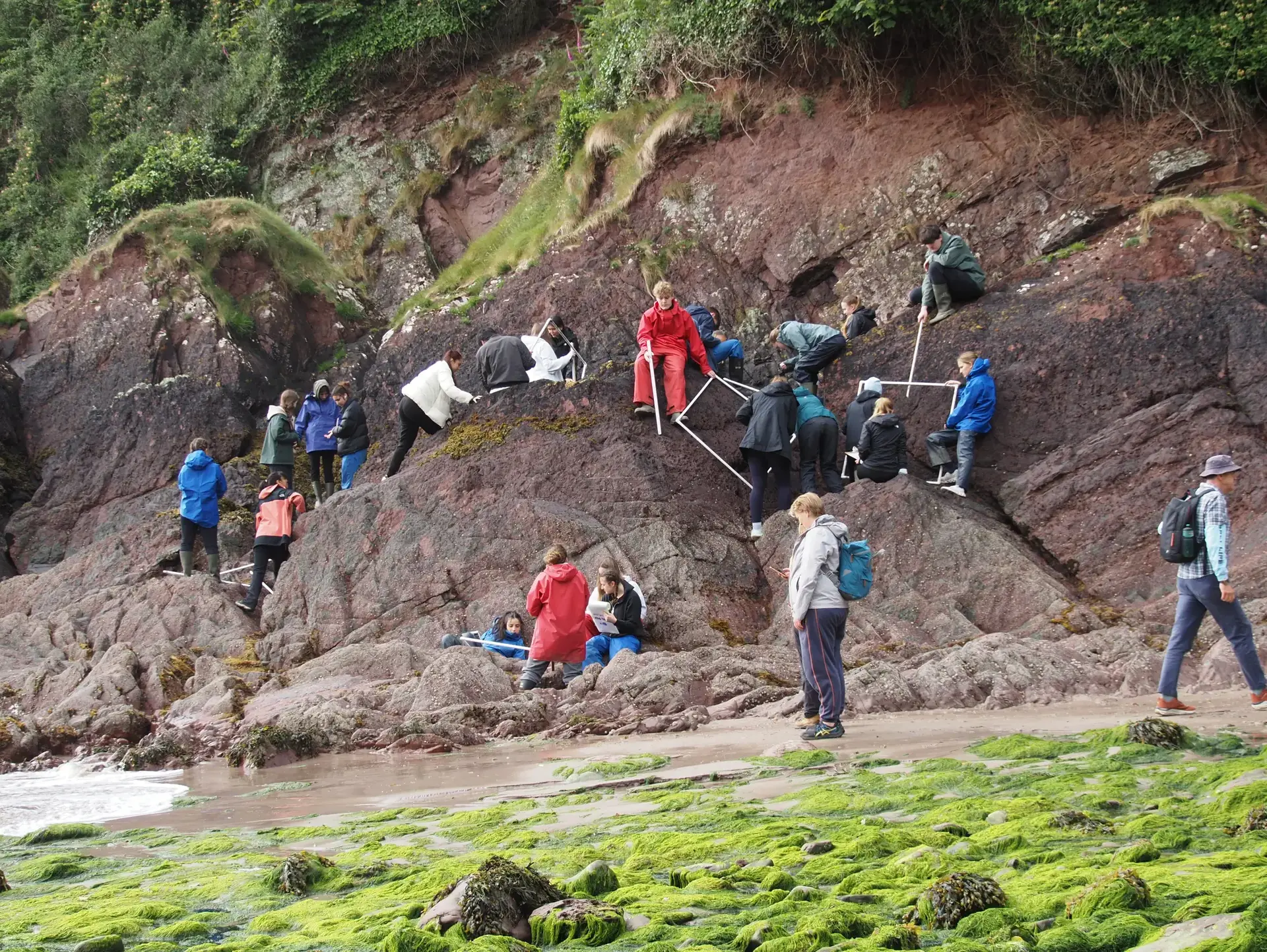 Students sitting on rocky outcrop