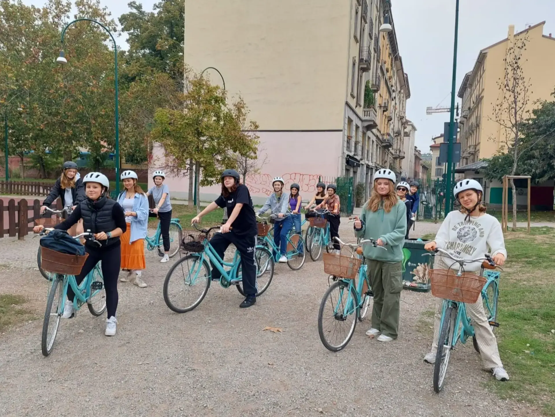Group of students sitting astride bikes