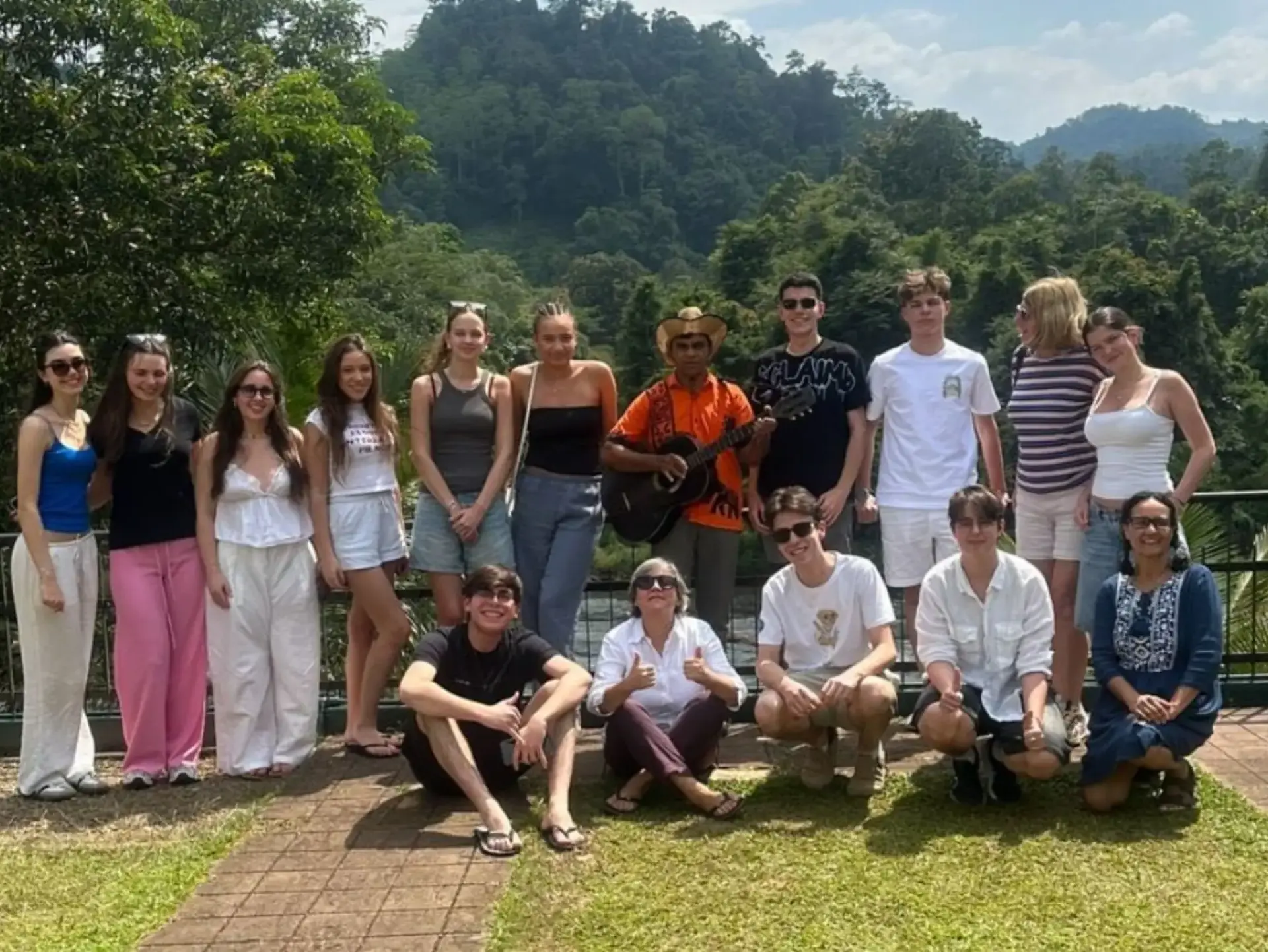 Group of students posing for photo on grass