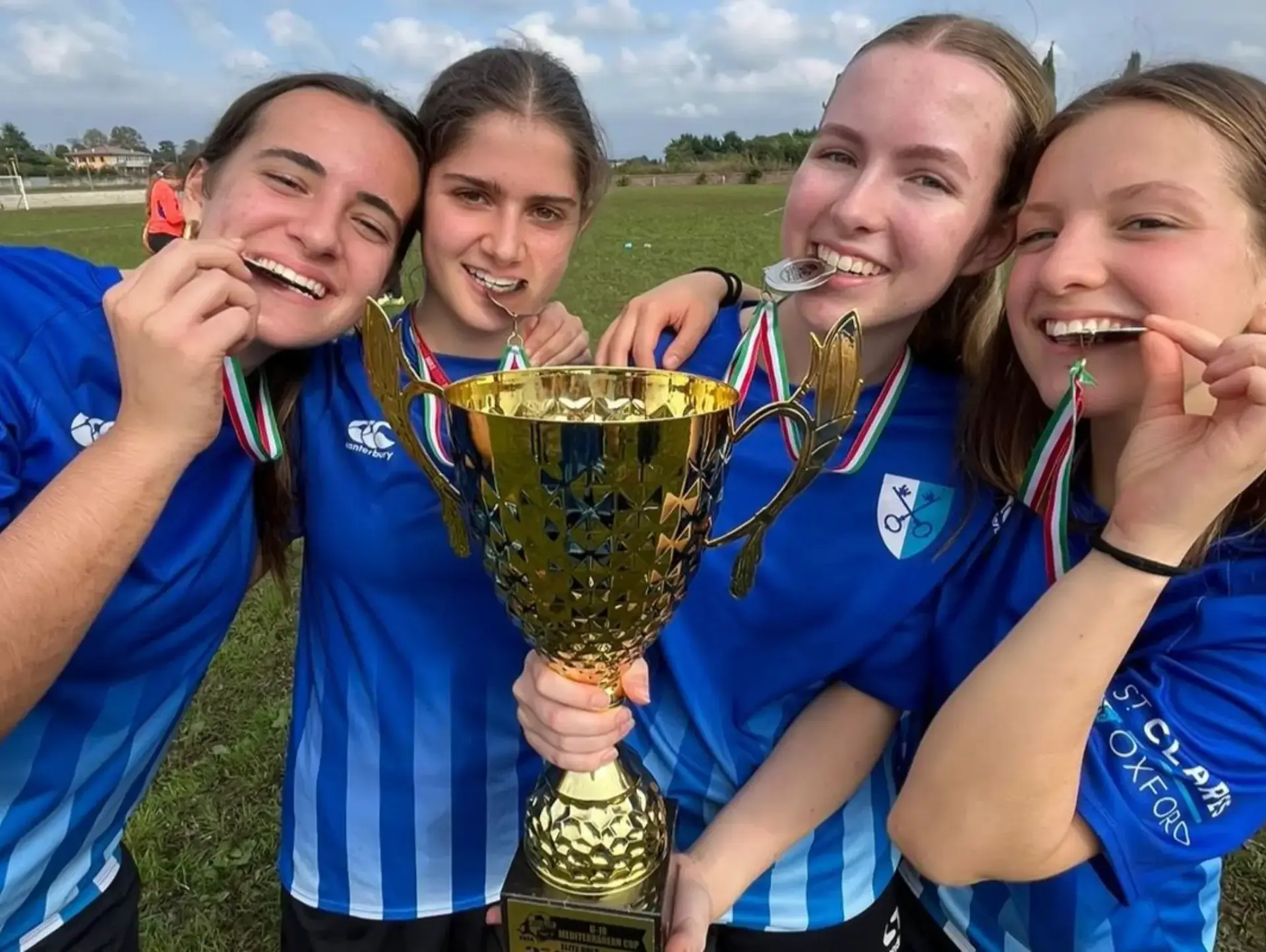 Students posing with trophy and medals