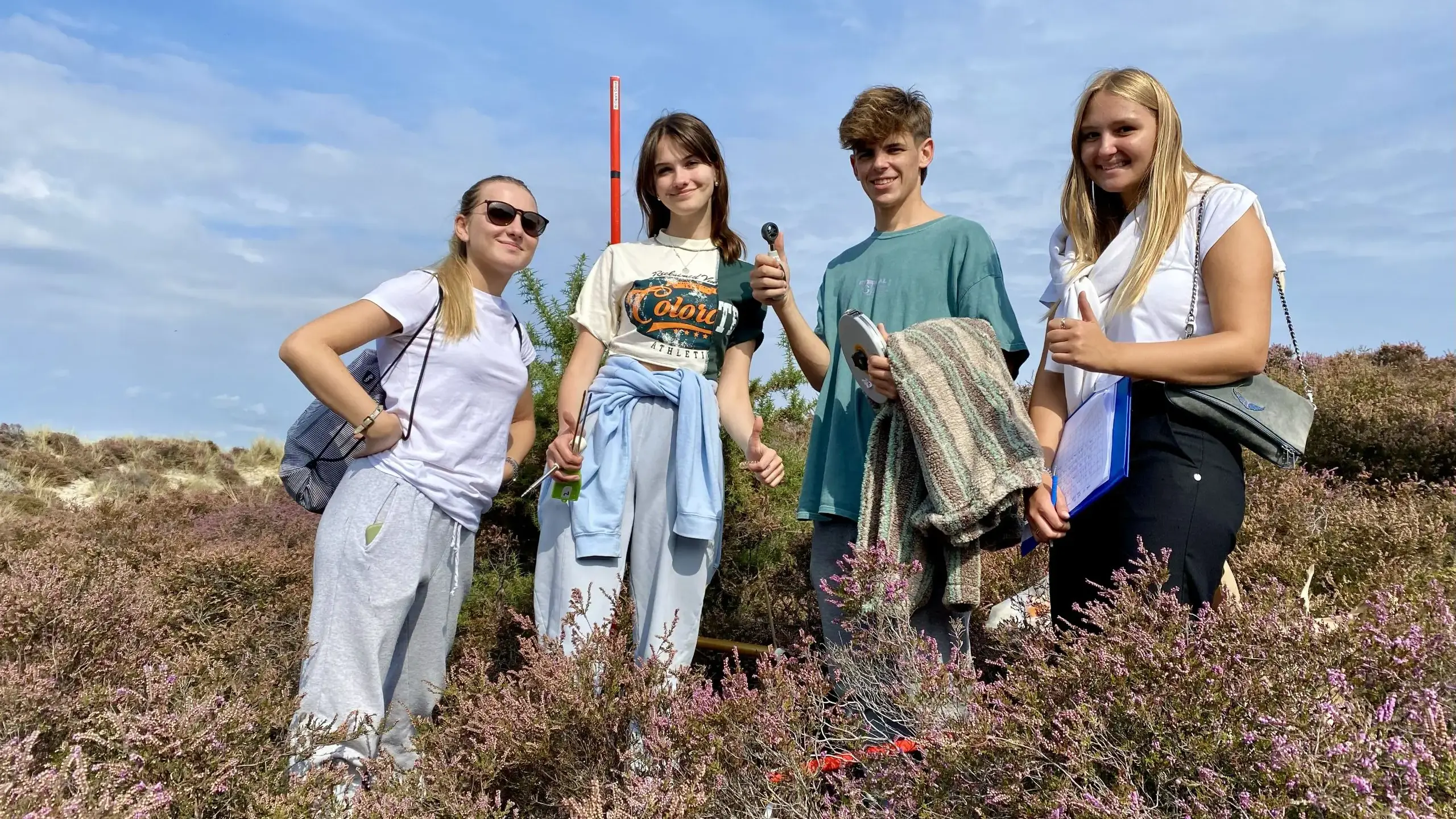 Four students posing outdoors for a picture