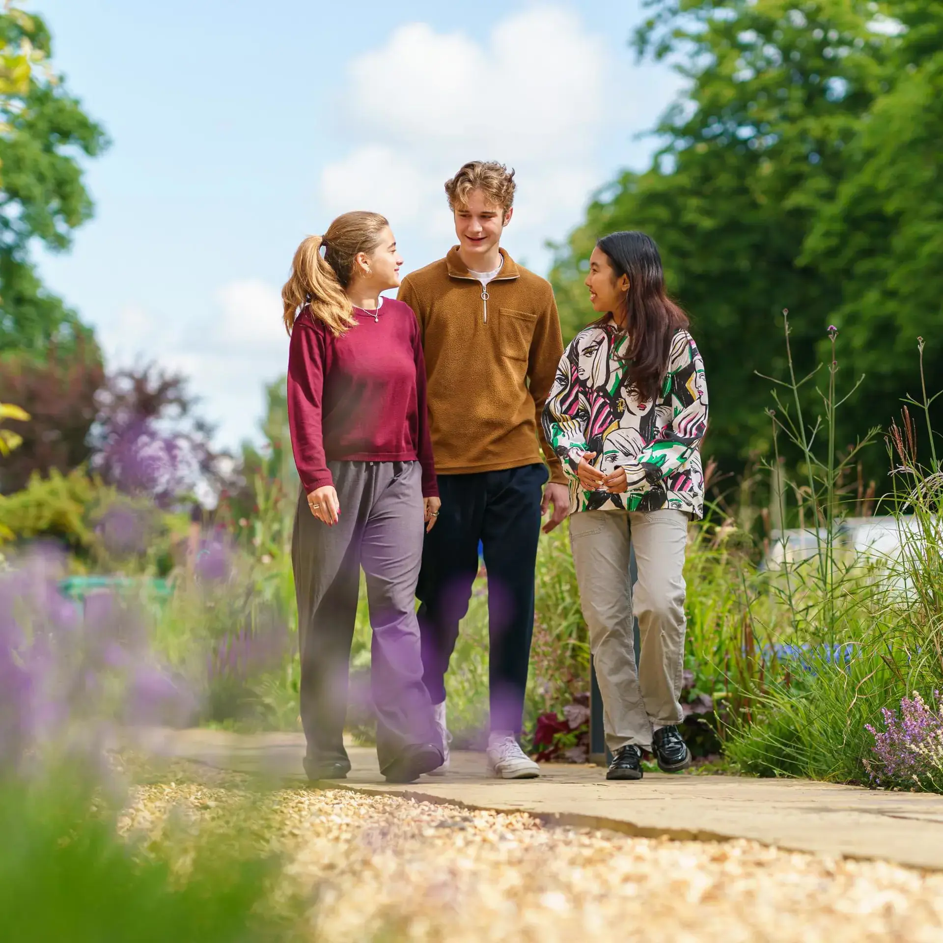 Three students walking together outdoors