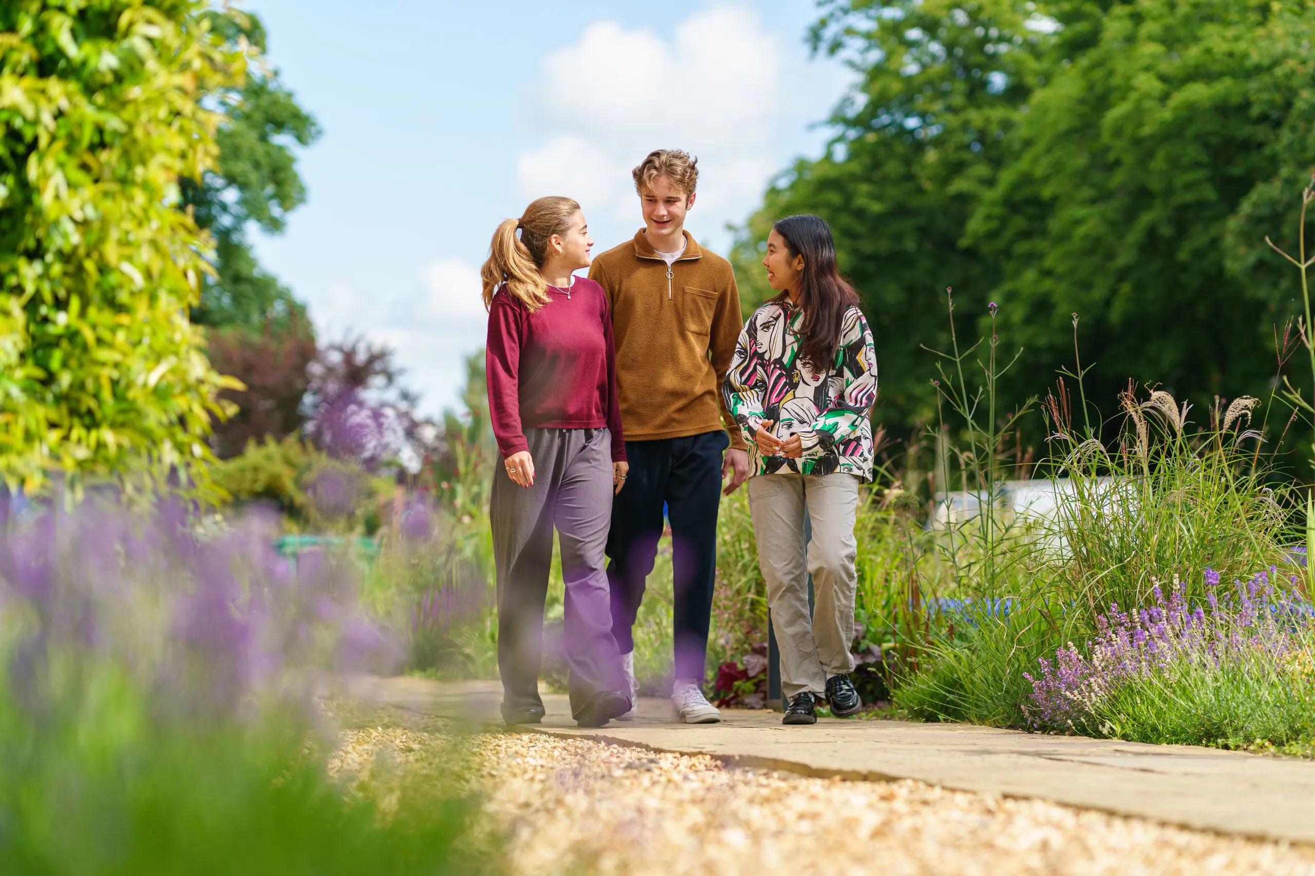 Students walking through campus gardens