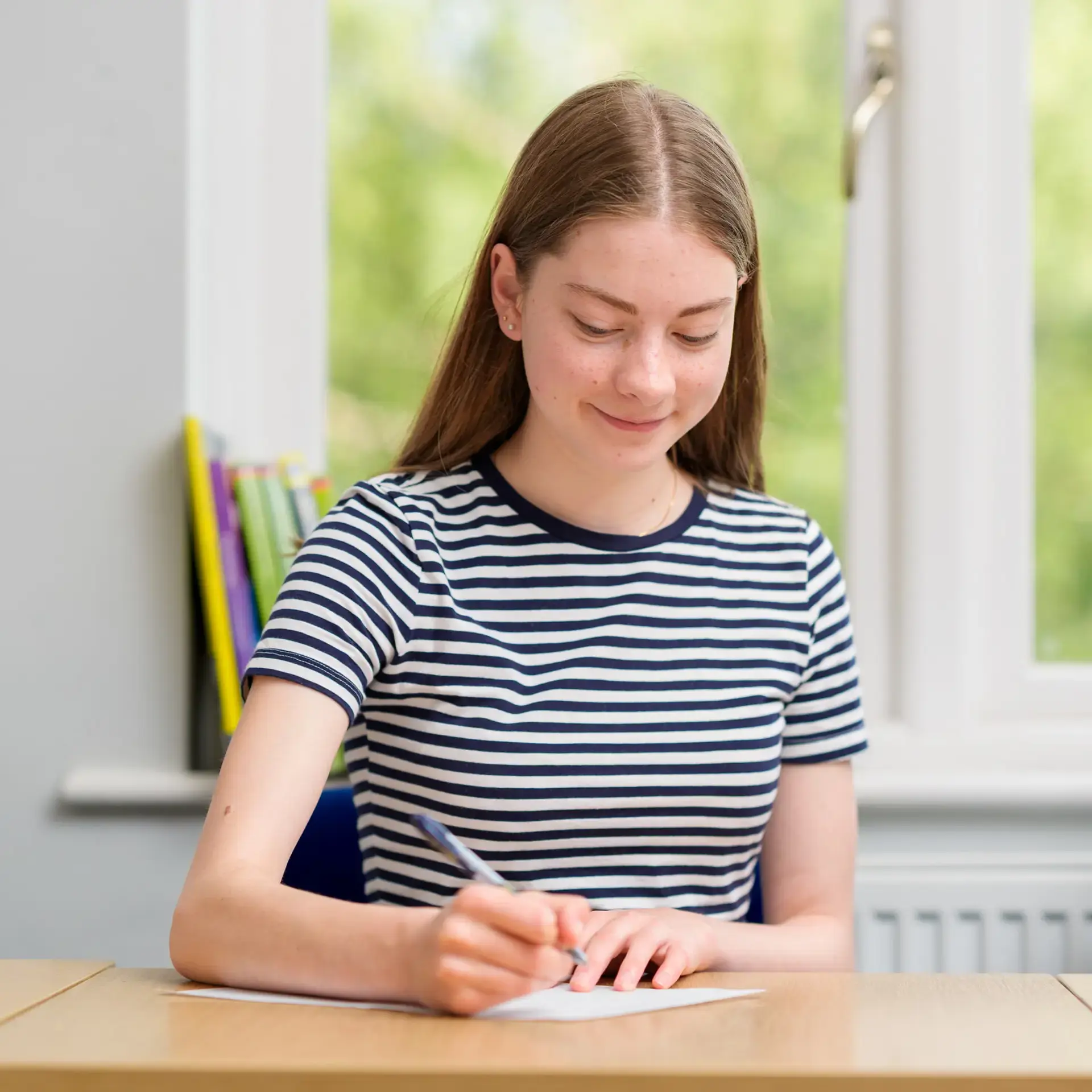 Student writing letter to pen pal
