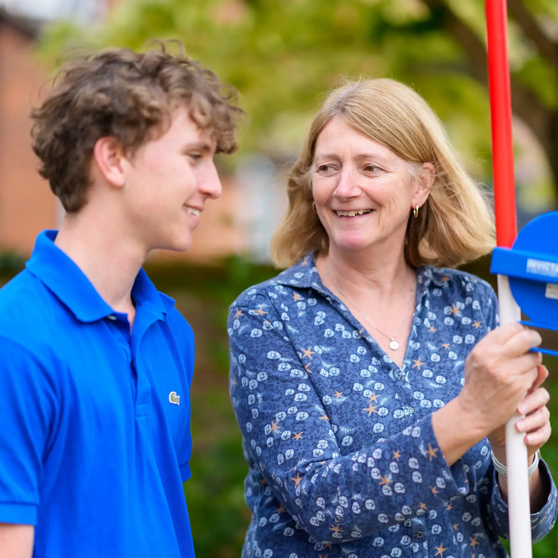 Student and teacher smiling together outdoors
