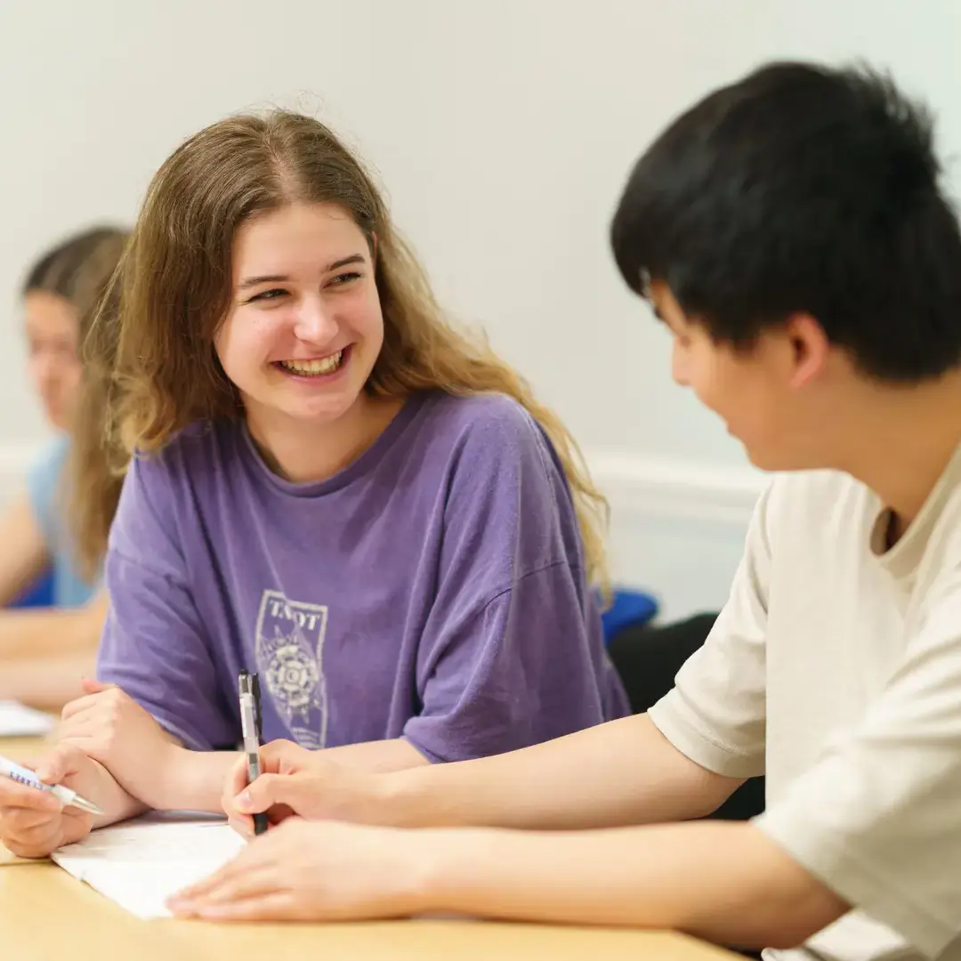 Female student in classroom smiling