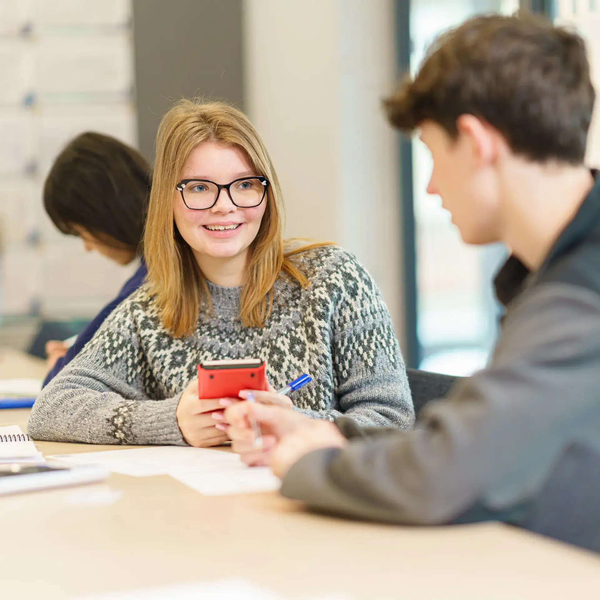 Students chatting at desk