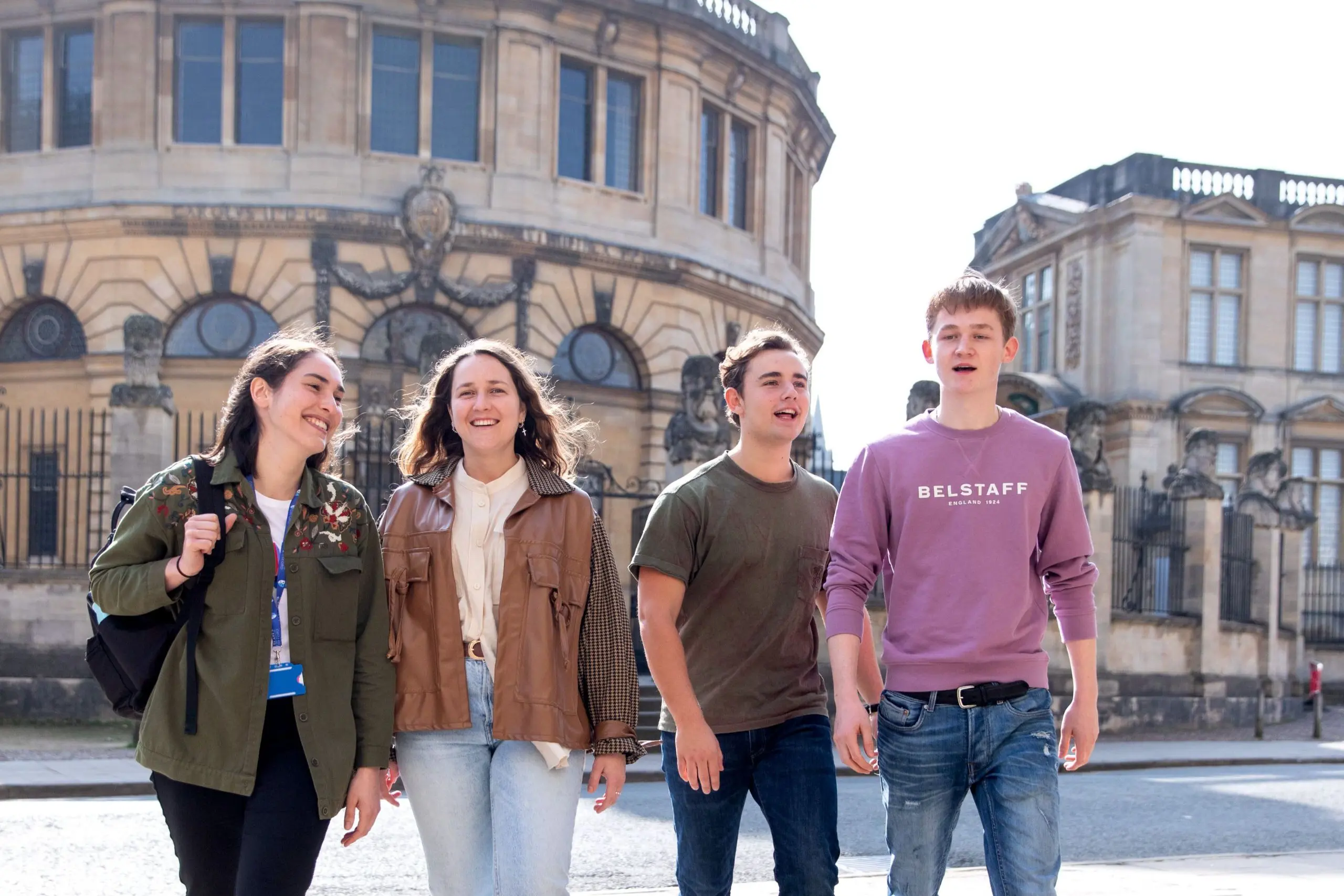 Group of students smiling and walking through Oxford.