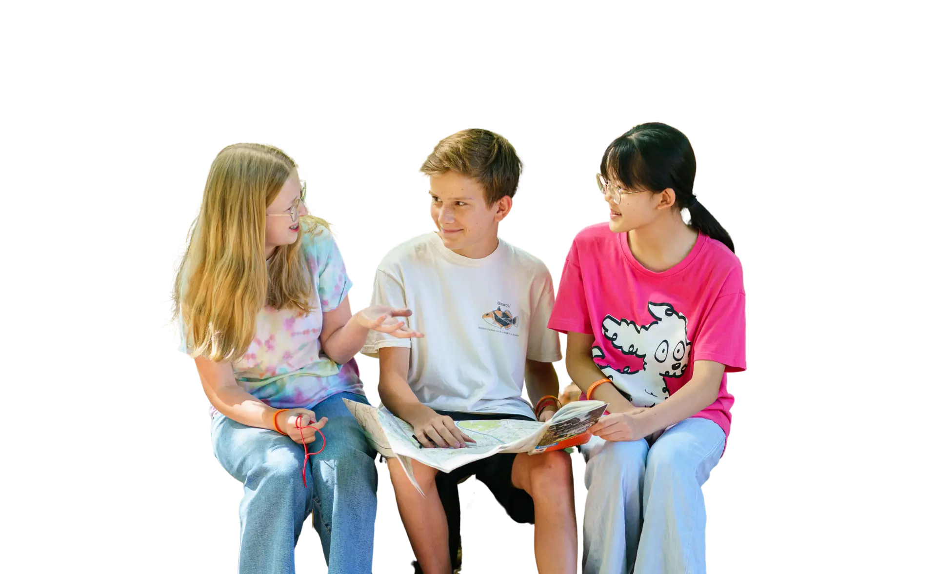 Summer students sat outside and reading a book together