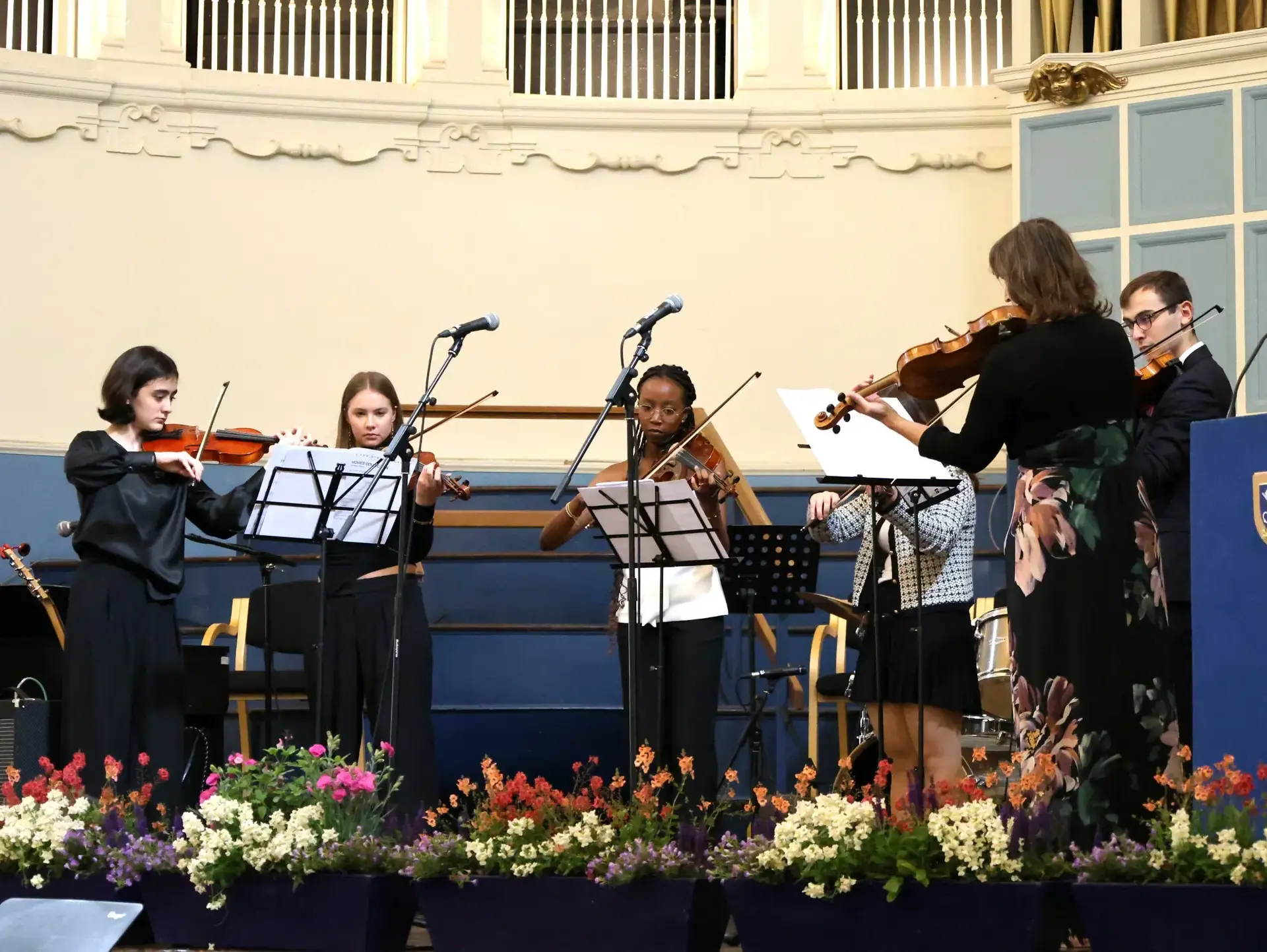Student orchestra performing onstage