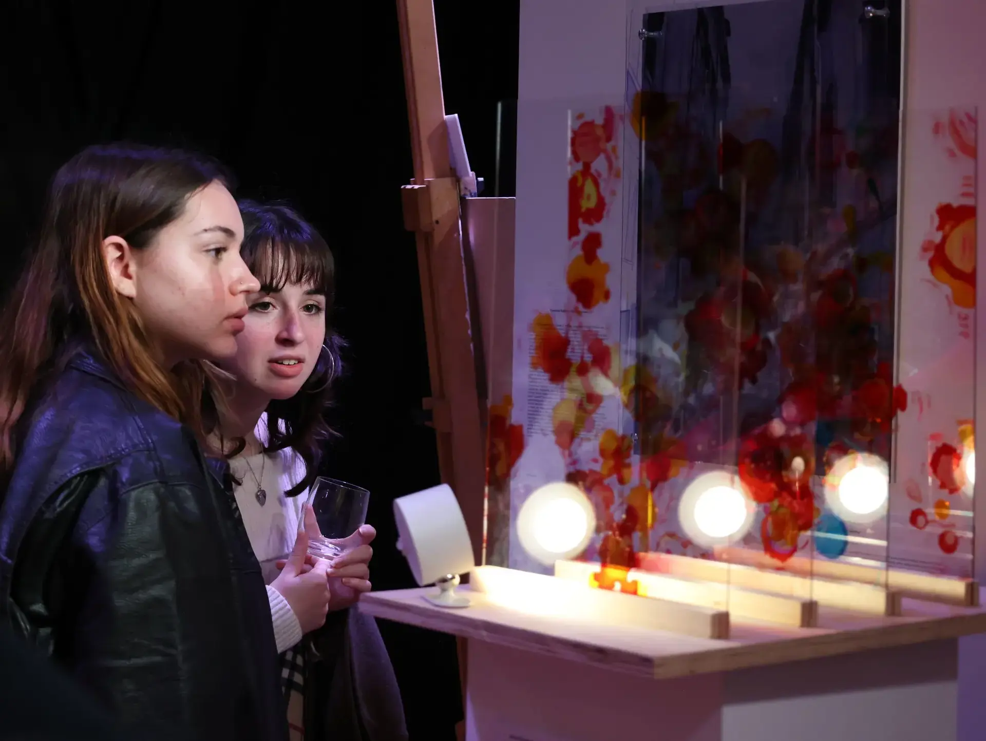 Students examining work at exhibition