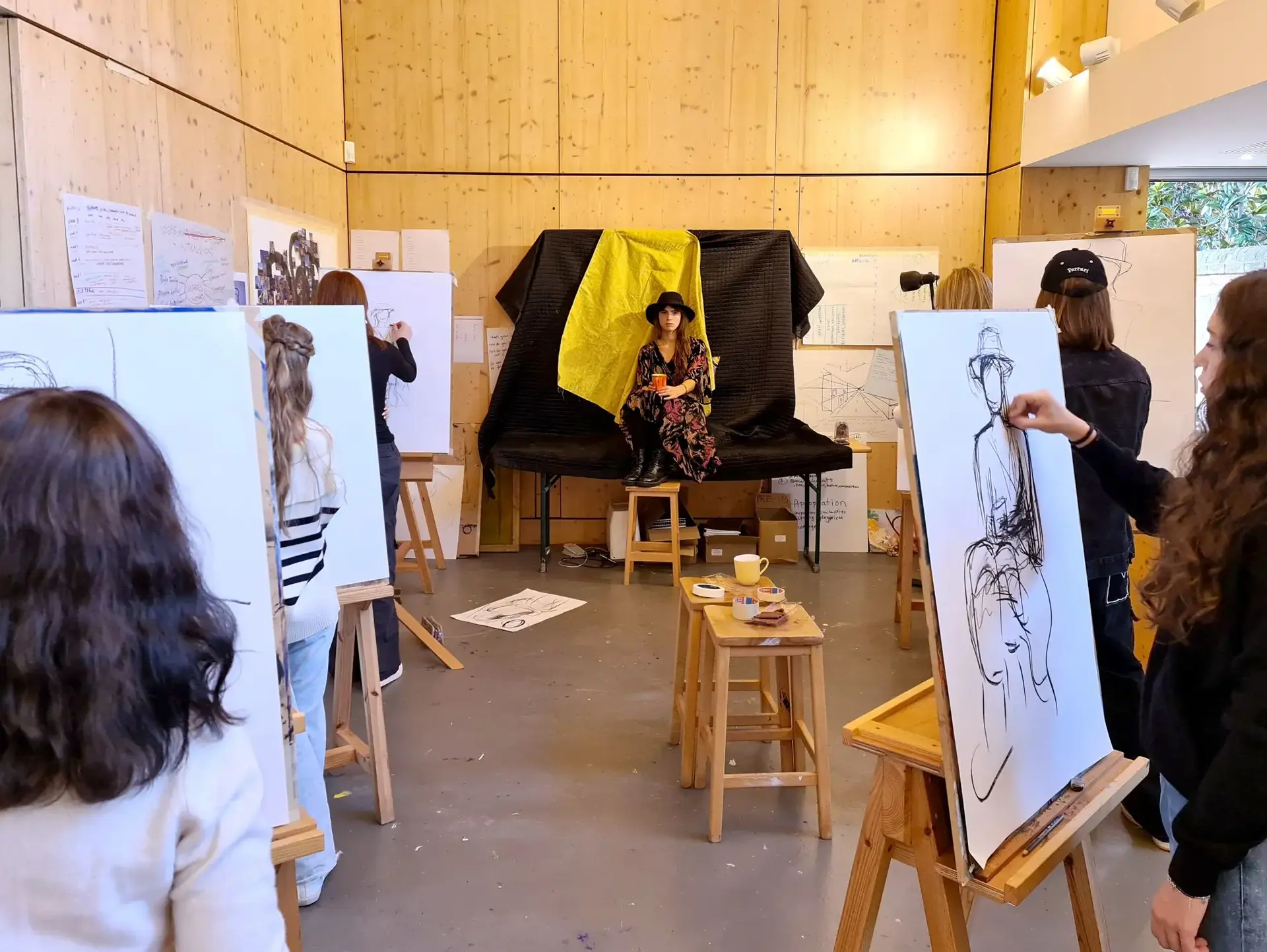 Students painting live model 