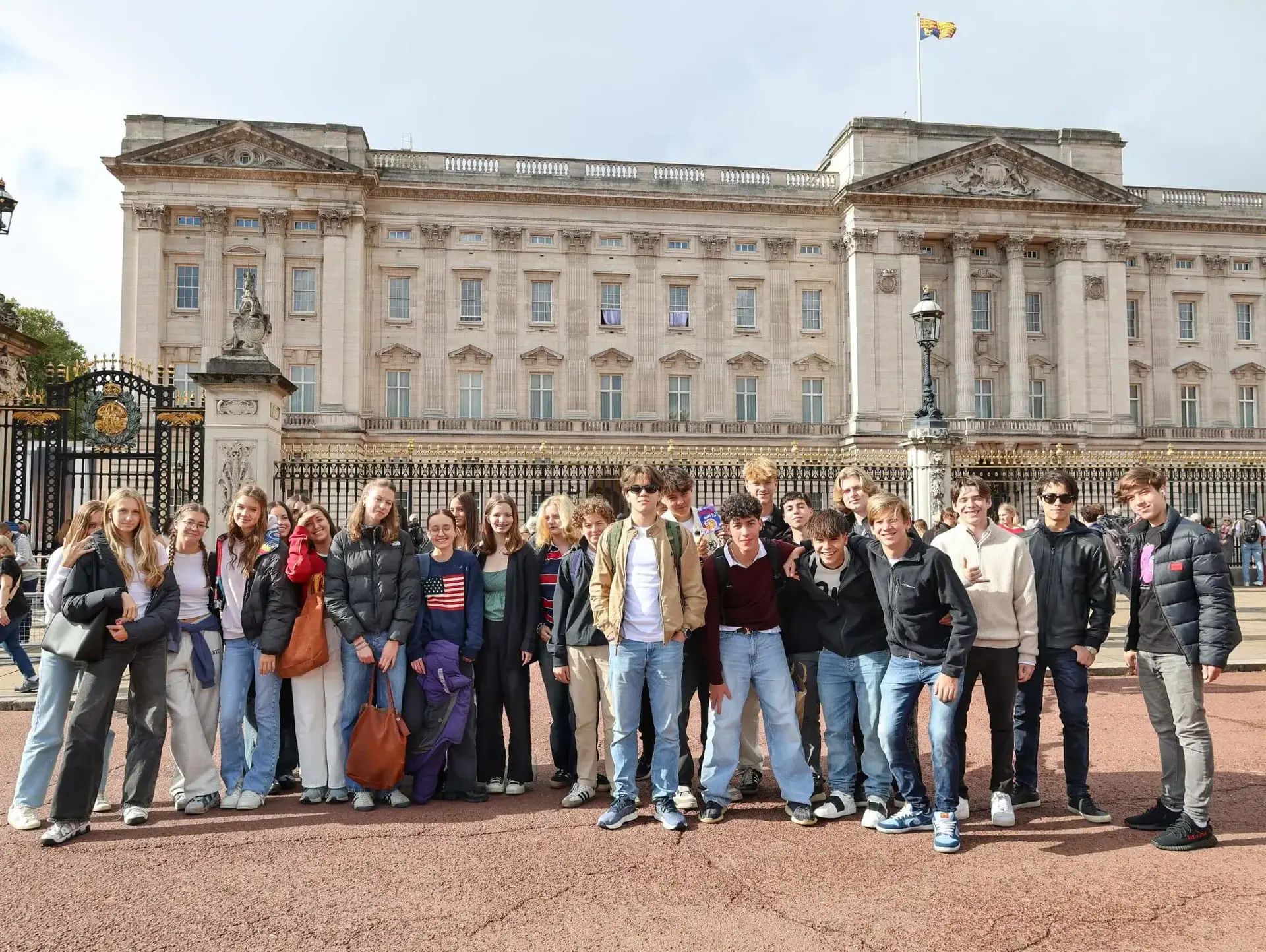 Group of students participating in a city tour outside Buckingham palace
