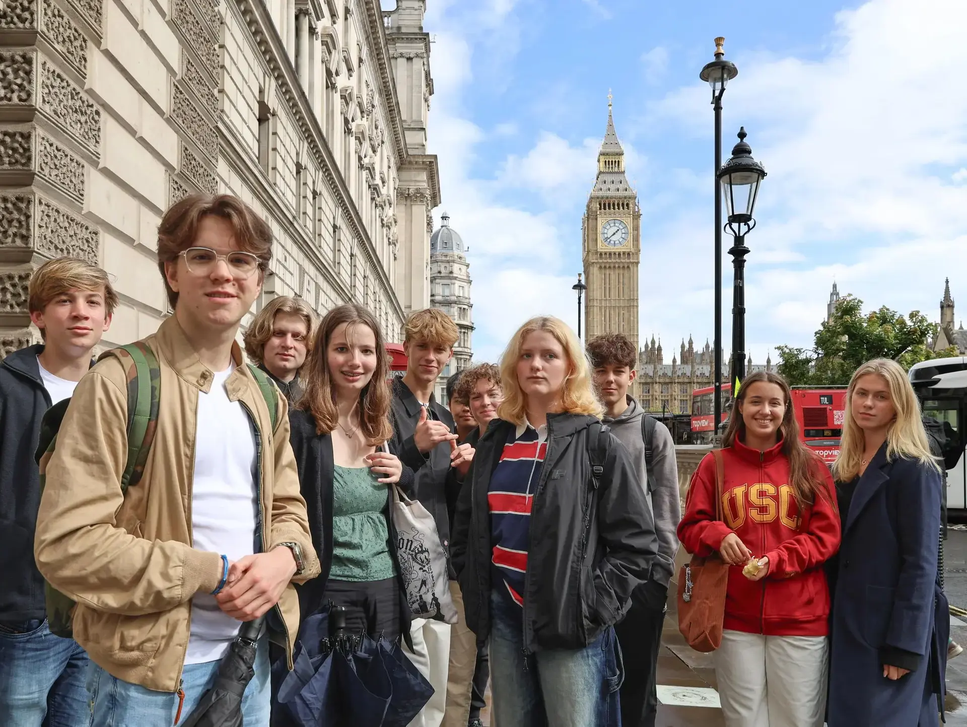 Group of students in a city tour with the Big Ben on the background
