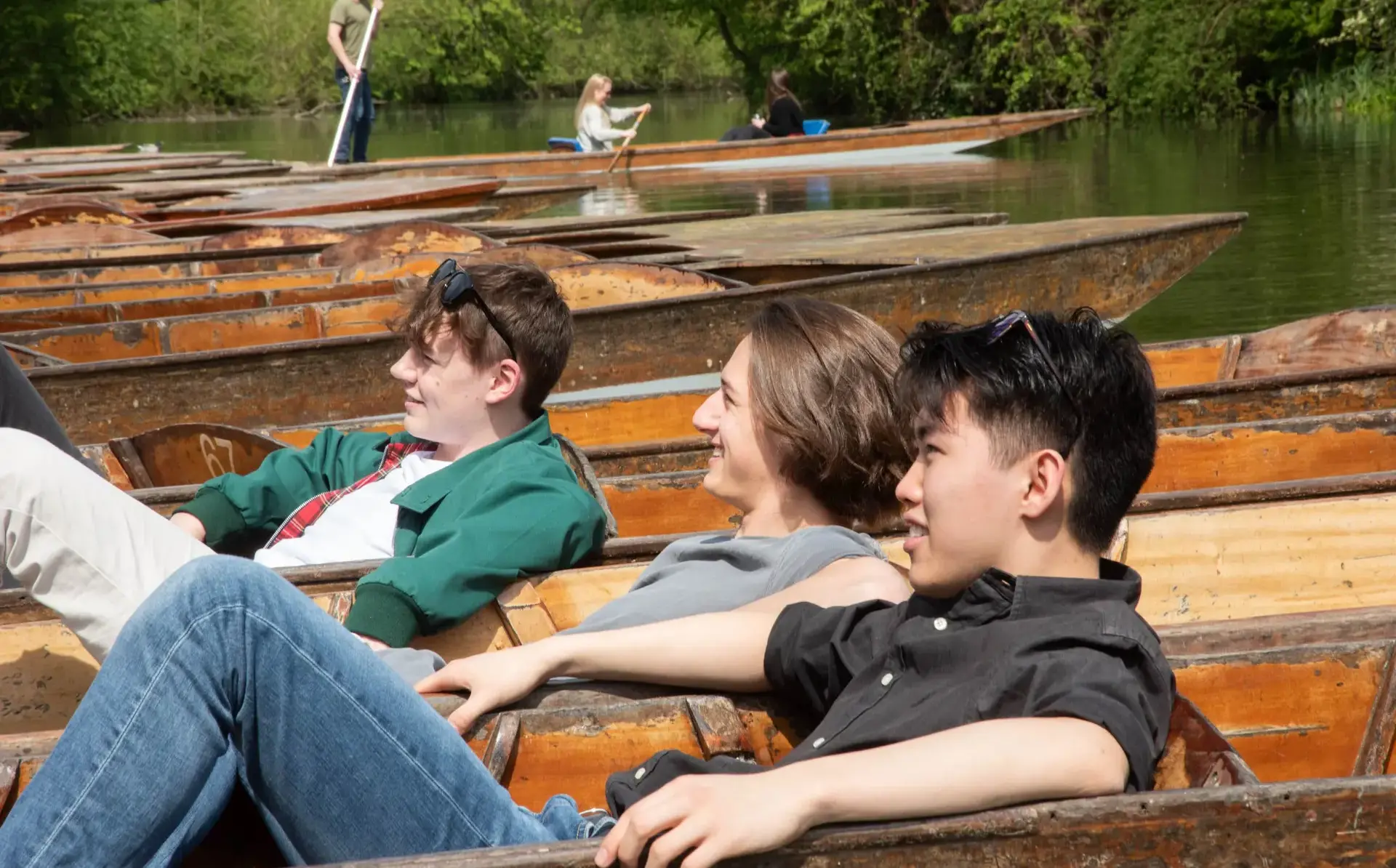 Students lounging in punting boats