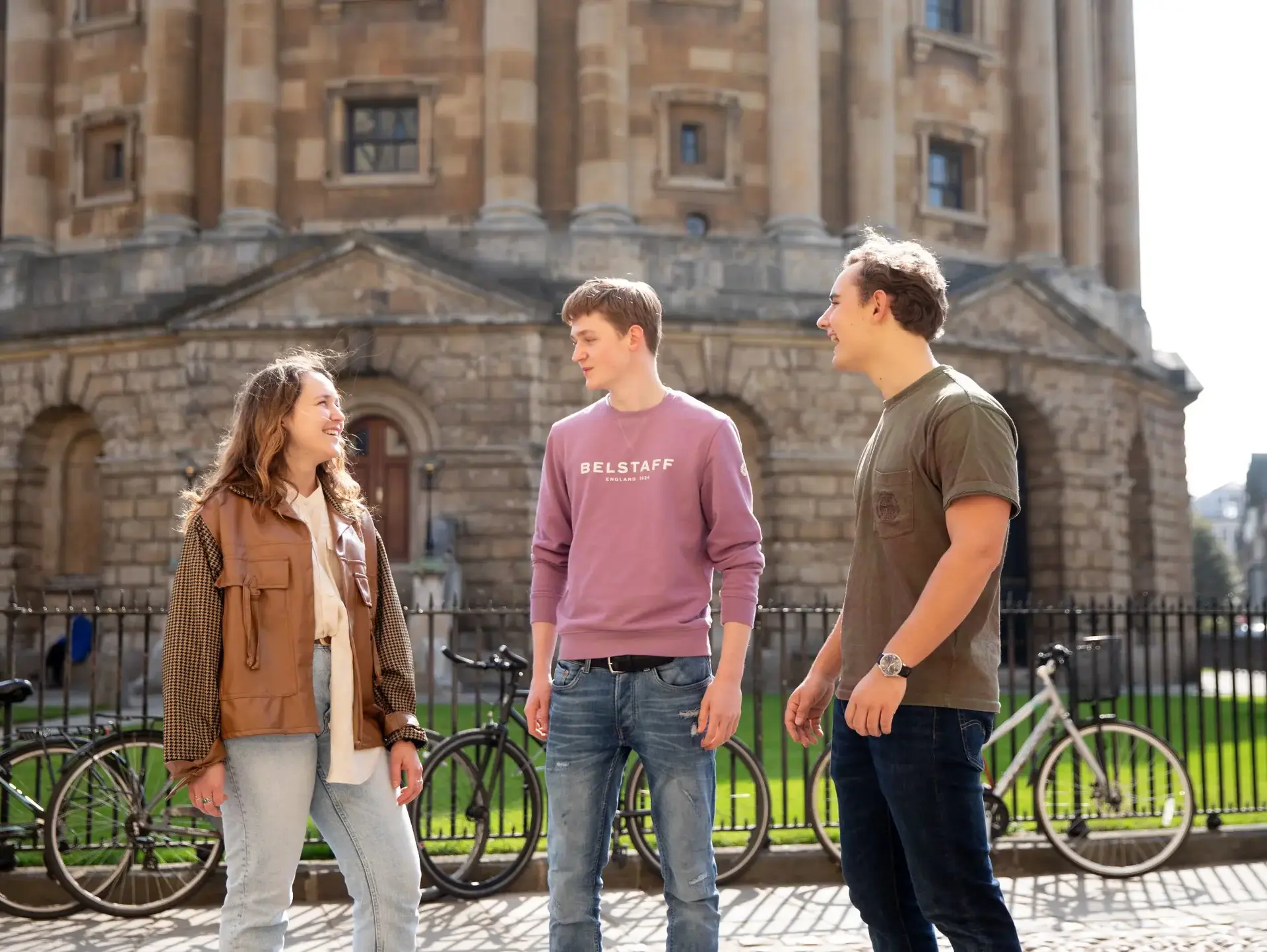 Three students chatting outside Bodleian Library