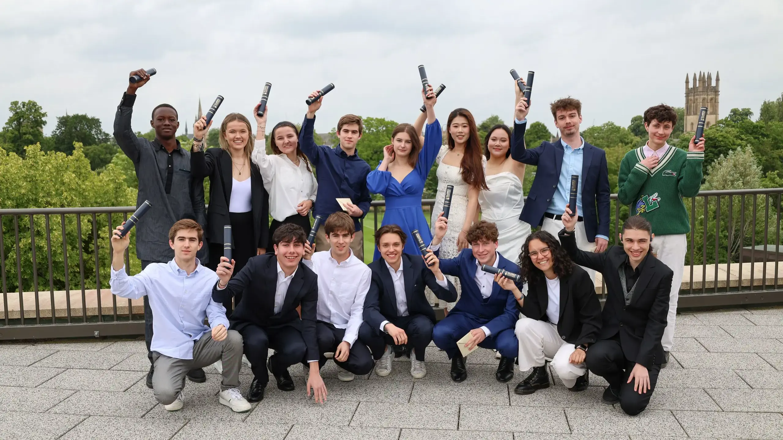 Group of celebratory students holding diplomas