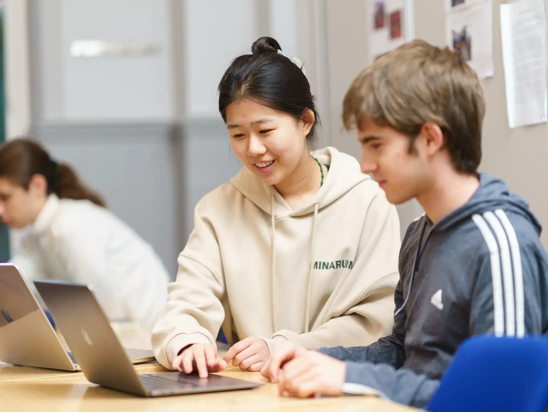Two students looking at laptop