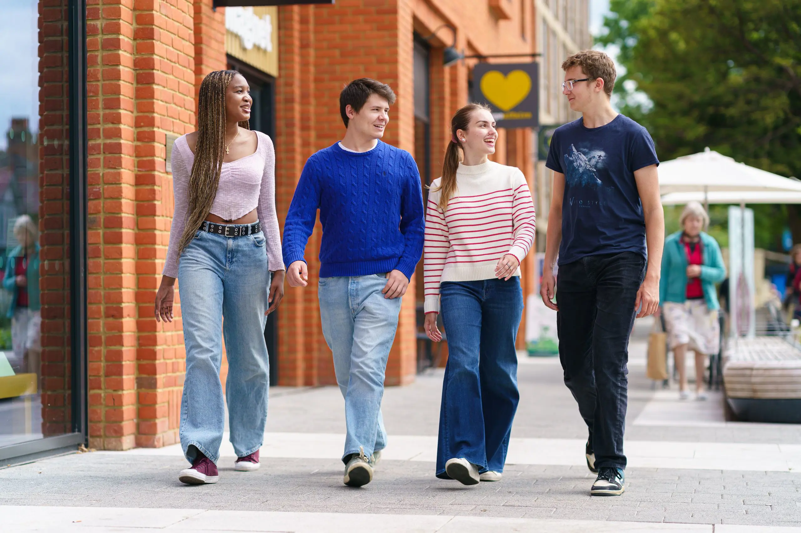 Four students walking down a high street