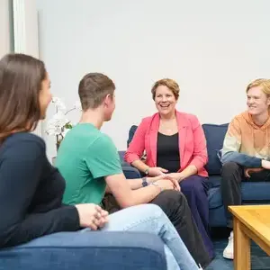Students talking and laughing with guidance counselor